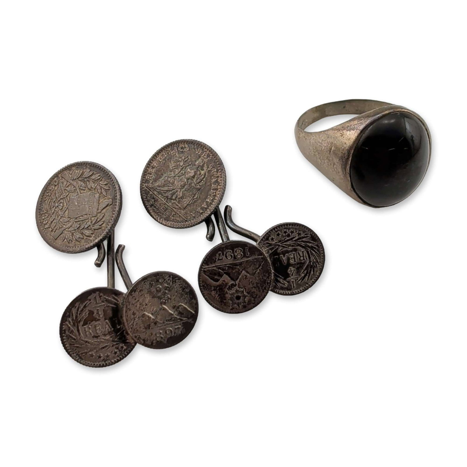 Three Sterling Silver and Coin Jewelry: Signet-style ring in sterling silver featuring a bezel-set oval black onyx cabochon with wide tapering shoulders. Interior of shank stamped 925. Pair of chain-link cufflinks constructed from 19th-cent