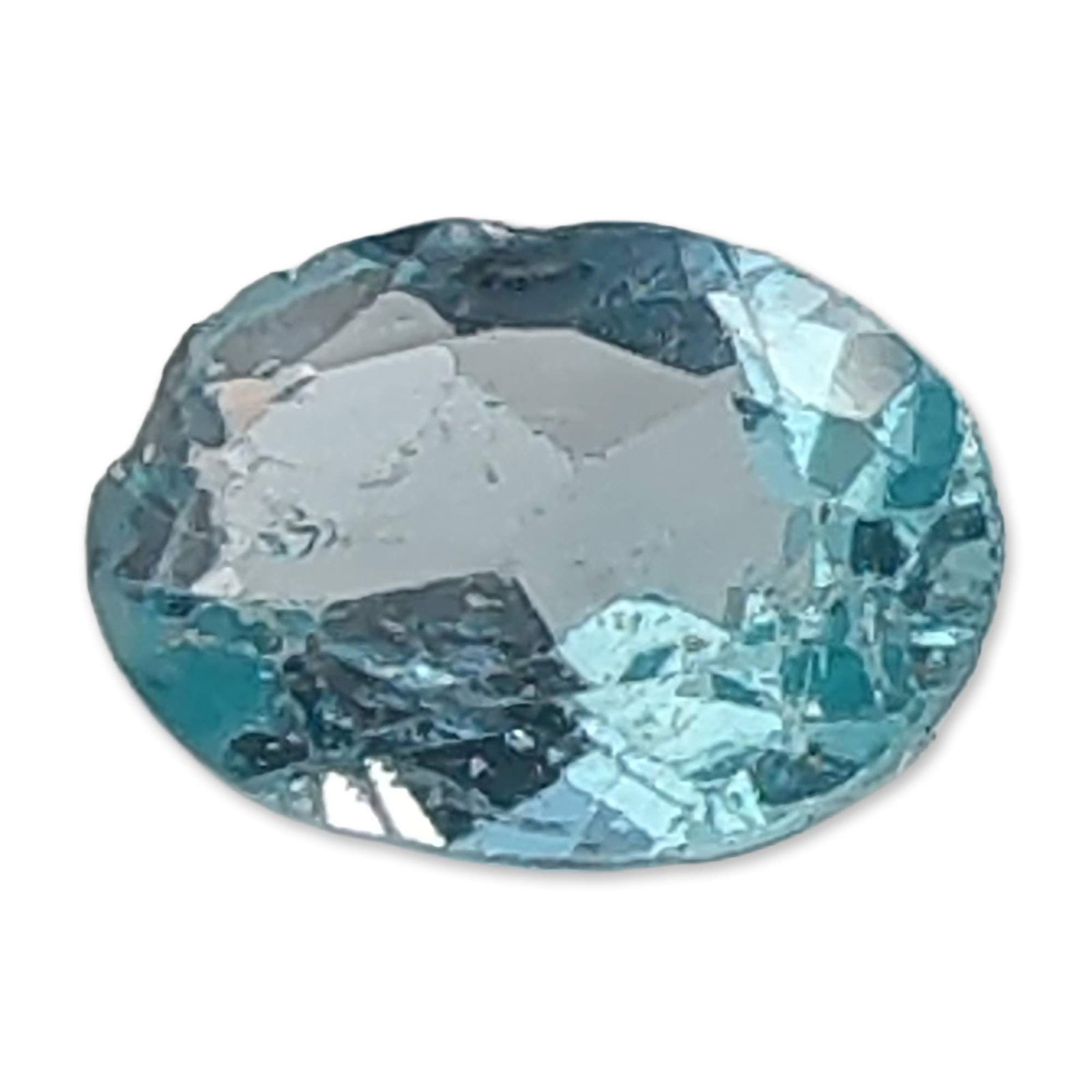 Oval Faceted Light Blue Apatite Gemstone: Loose faceted Apatite gemstone, Oval cut with a light sky blue hue and transparent clarity. Visible internal characteristics include veils and a linear inclusion extending across the table facet. 0.7