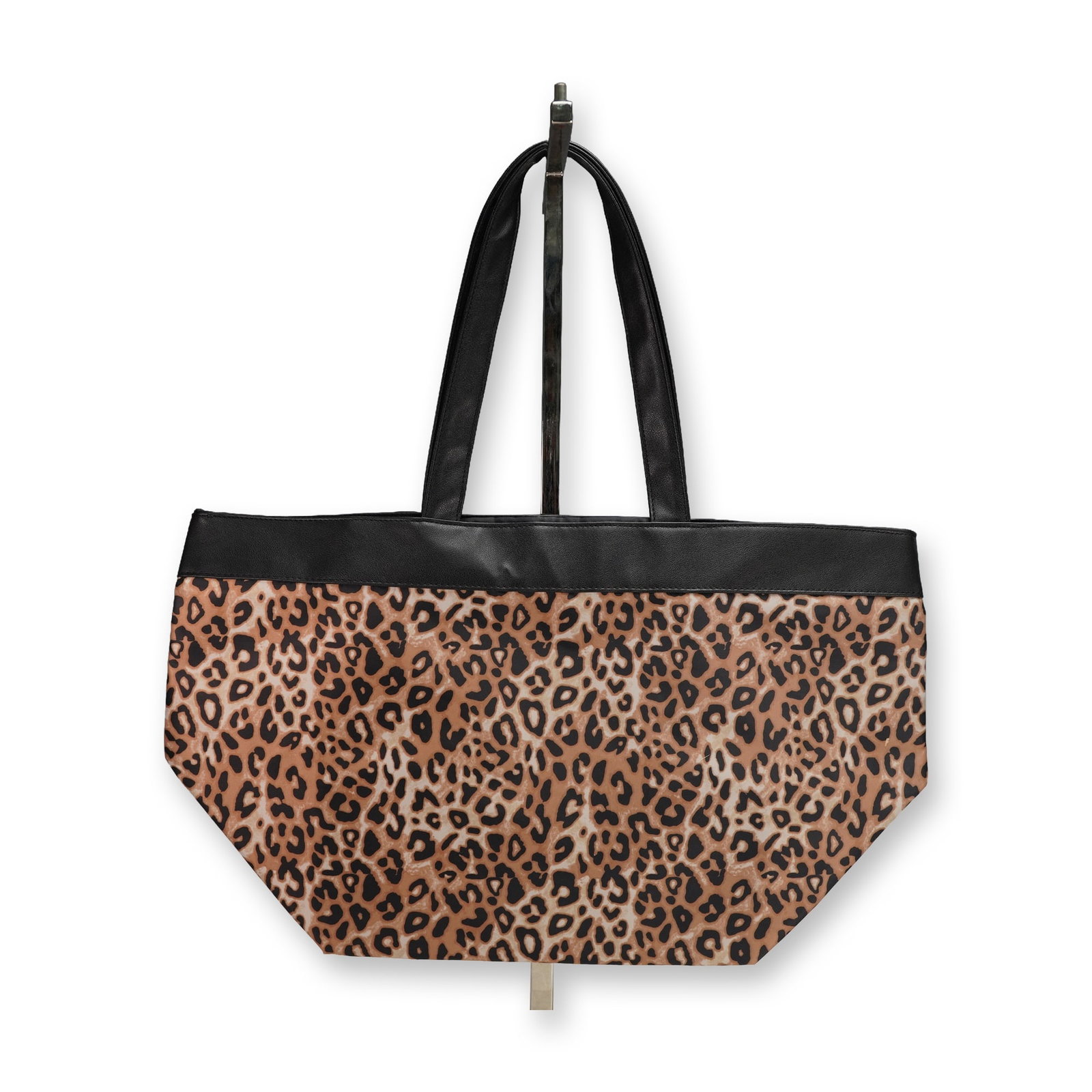 Bloomingdales Leopard Print Faux Leather Trim Tote Bag: A modern tote bag featuring a distinctive leopard print pattern across the main body, crafted from a waterproof material. It is designed with a black trim along the upper edge and two black top handle