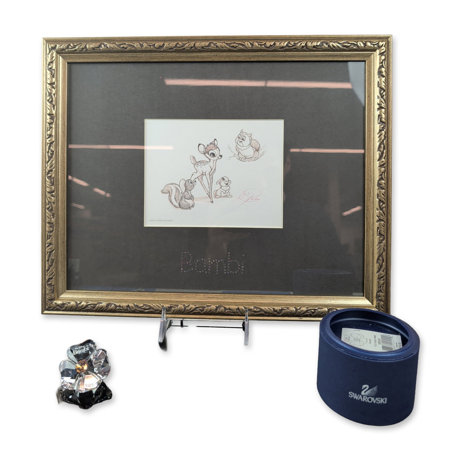 2pc Disney Swarovski Bambi Lithograph and Title Plaque and COA: This set by Disney Master Artist Dave Pacheco for Swarovski features a framed lithograph and crystal figurine inspired by Disney's Bambi. The lithograph showcases Bambi, Thumper, Flower, and Friend Ow