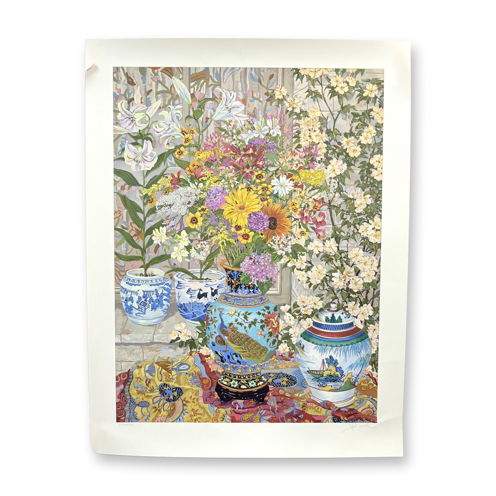 John Powell Treasures and Tiger Lilies Signed and Numbered Serigraph: John Powell, Treasures and Tiger Lilies, serigraph on paper. This vibrant still life composition features a central light blue ceramic vase decorated with a peacock and floral patterns, filled with a 