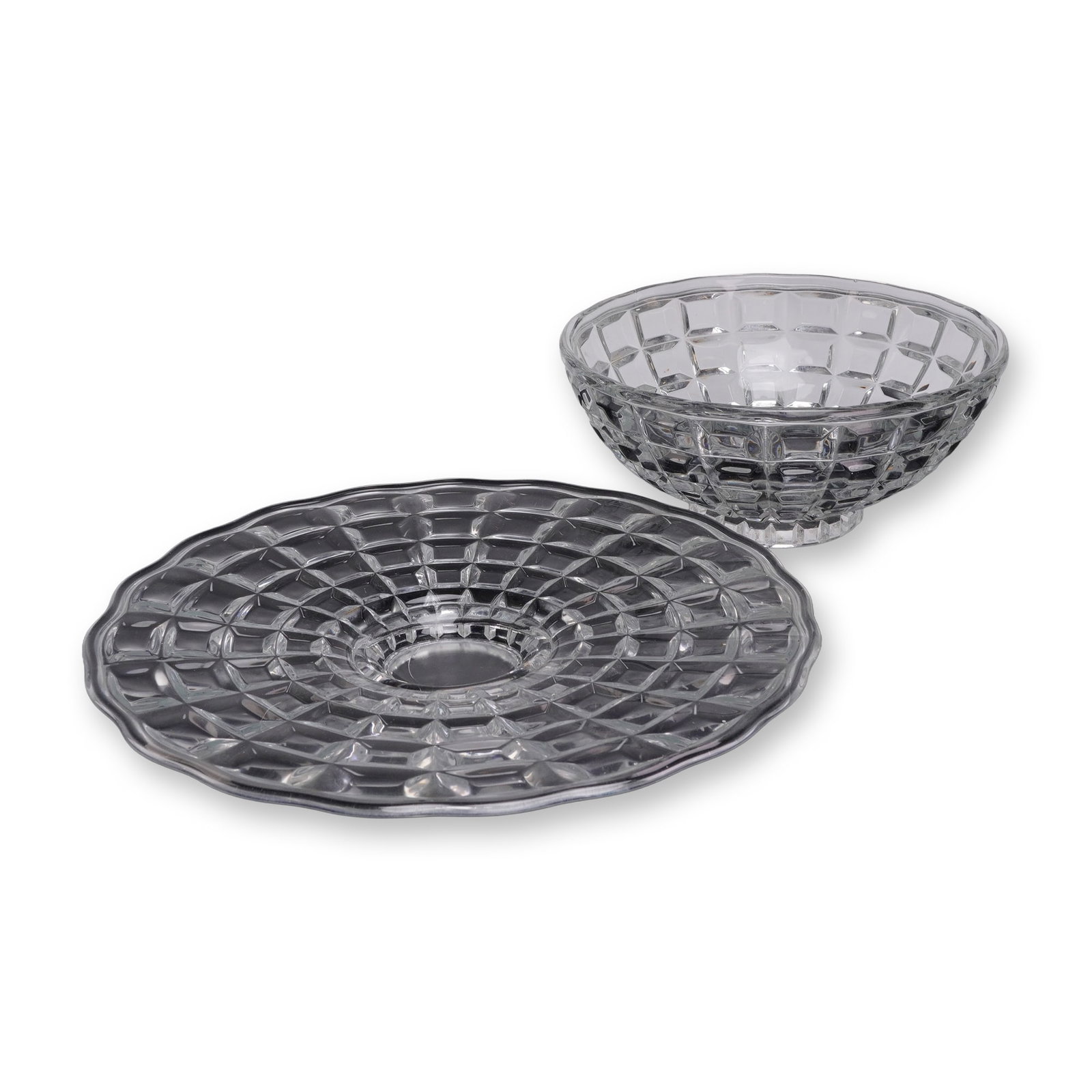 A Set of Two Crystal Glass Cut Block Pattern Serving Bowl & Plate: This set of two heavy, quality glass pieces comprises one bowl and one plate. The clear crystal glass is decorated with concentric rings of raised, convex rectangular blocks. The round serving plate f