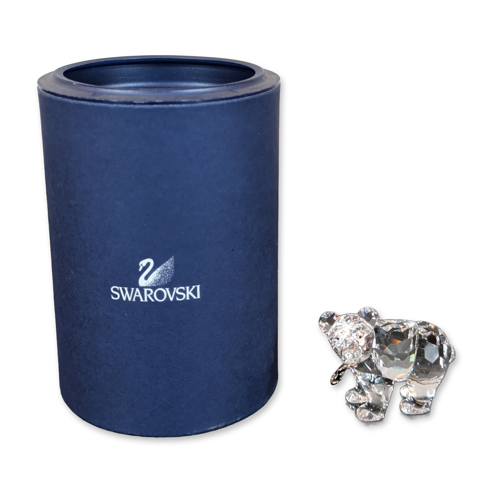 Swarovski Crystal Grizzly Bear Cub Figurine: Swarovski Crystal figurine in clear faceted crystal, depicting a standing bear cub with small black eyes. Features an etched swan logo to the underside of a front paw. Accompanied by original blue cyl