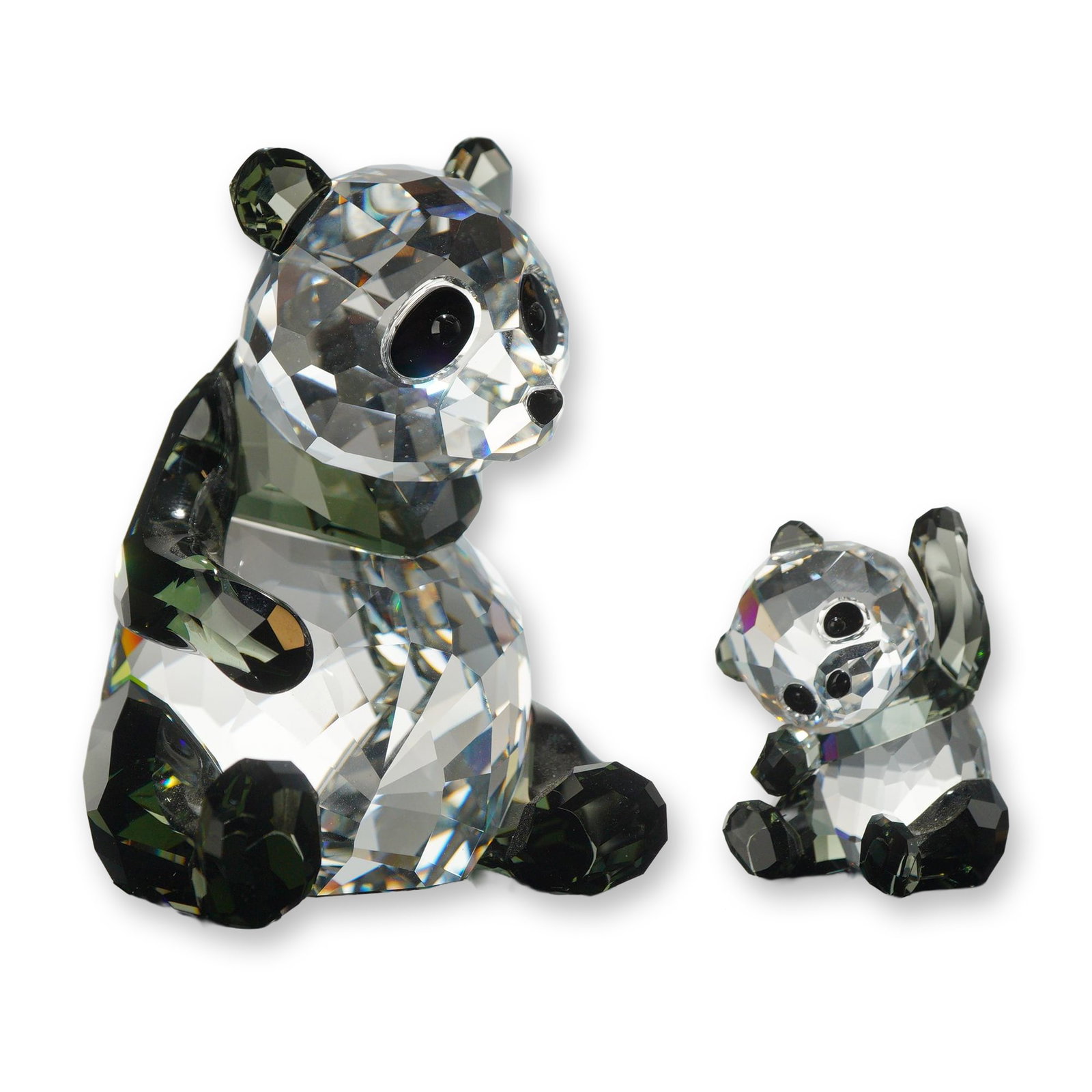 Swarovski Crystal Panda Mother and Baby Figurines: Swarovski SCS annual edition crystal figurines depicting a Panda Mother and Baby. Crafted in faceted clear and dark-colored lead crystal to represent the natural markings of giant pandas. The mother p