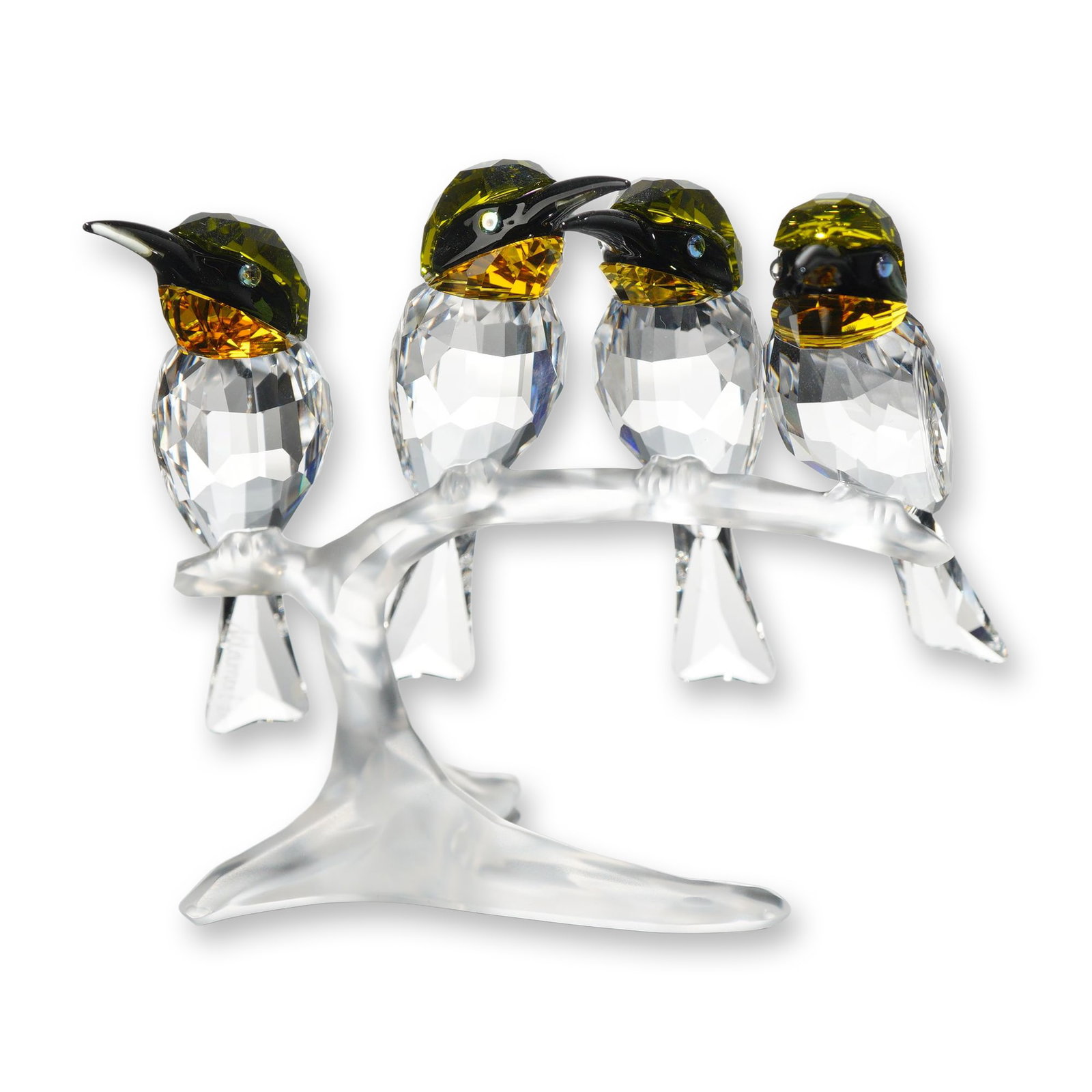 Swarovski Crystal Bee Eaters Figurine Signed Elisabeth Adamer: Swarovski faceted lead crystal figurine depicting a group of bee-eaters on a branch. Designed by Elisabeth Adamer, the piece features clear faceted crystal bodies and tails. The heads are crafted in a