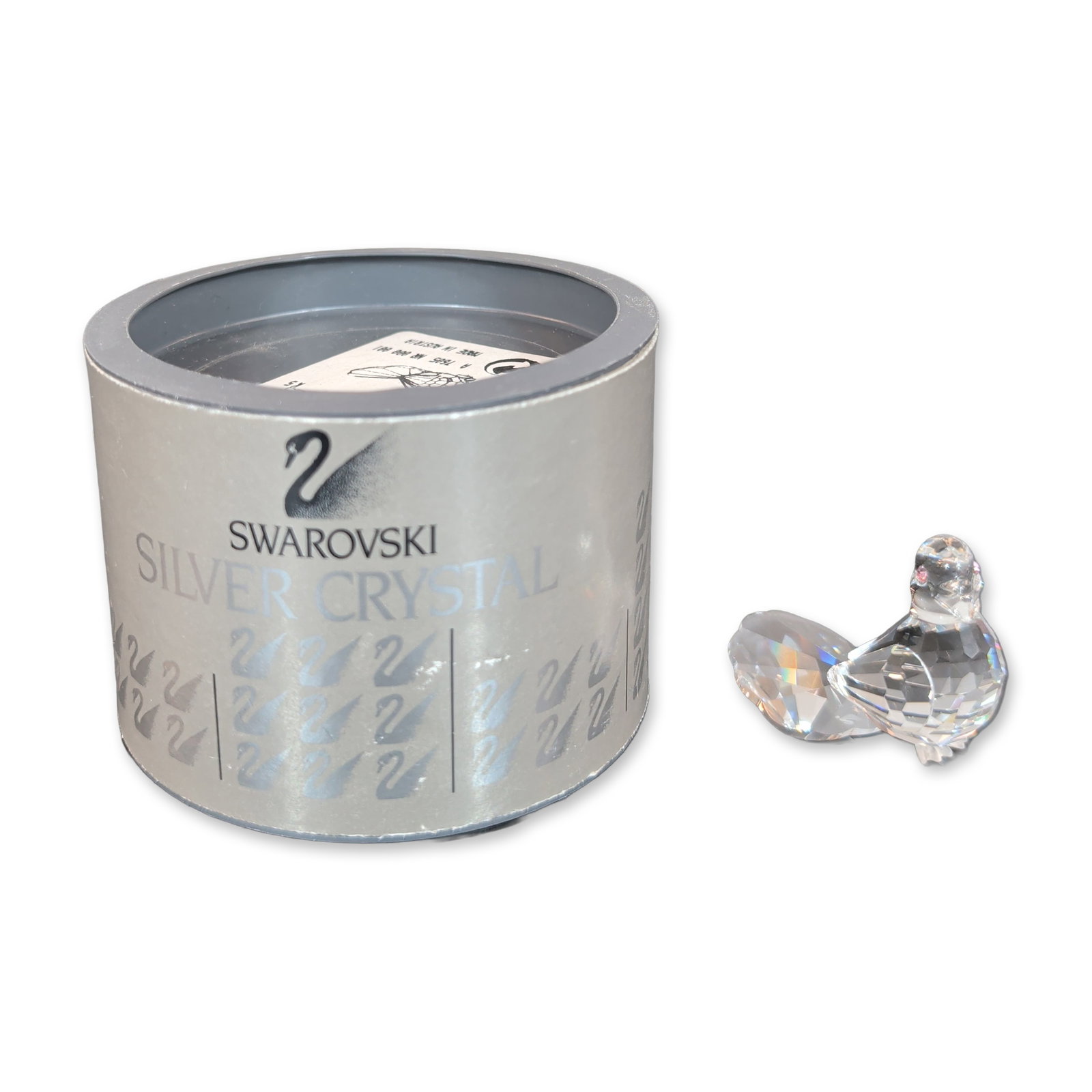 Swarovski Silver Crystal Dove Figurine: A Swarovski Silver Crystal Dove figurine featuring small pink crystal eyes. The base is marked with an etched Swarovski swan logo and copyright symbol. The item is accompanied by its original cylindri