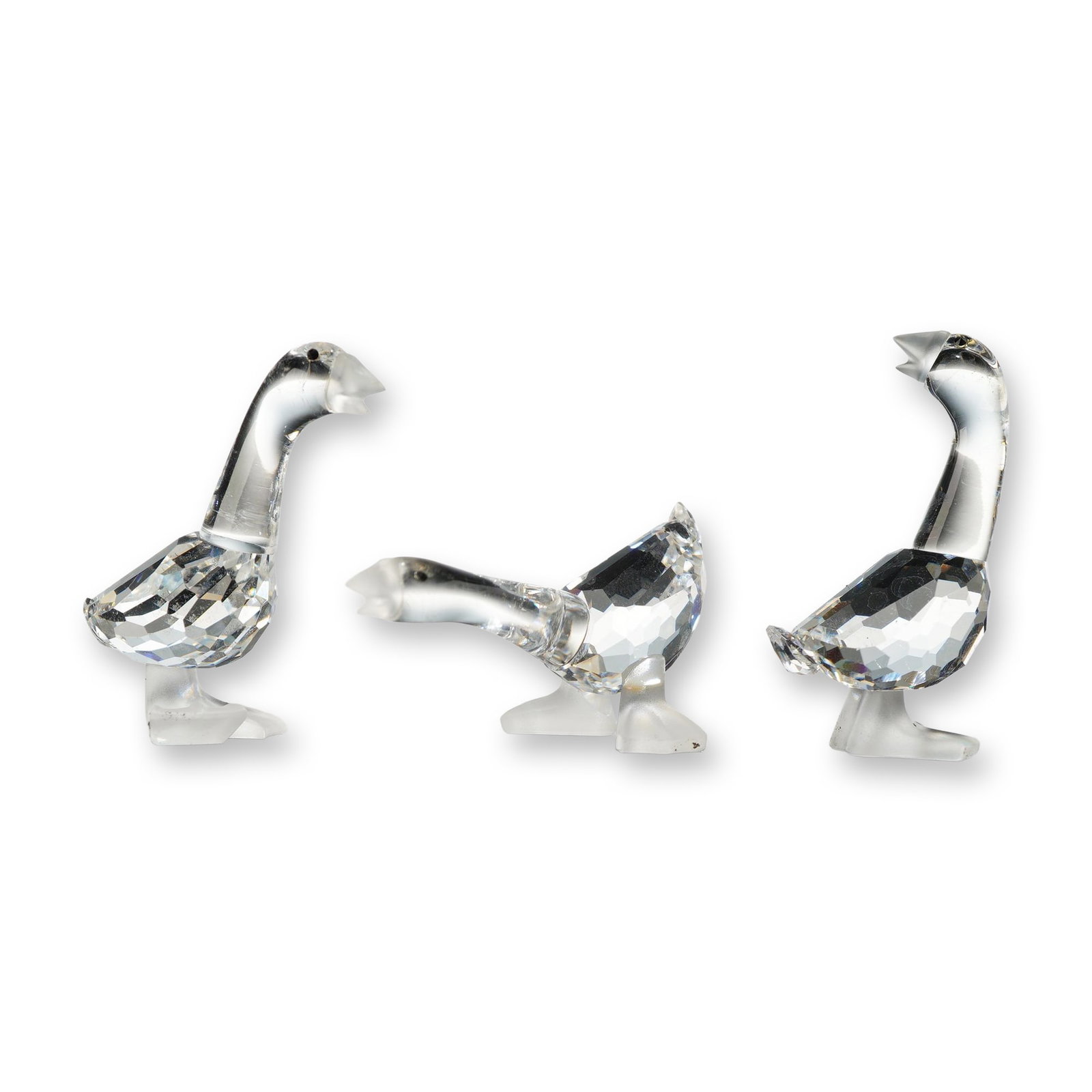 Swarovski Silver Crystal Figurines, Goslings: Tom, Dick and Harry Gosling figurines in faceted lead crystal with molded smooth crystal necks and heads. The set features geese in three distinct poses: grazing with neck extended, standing upright, 