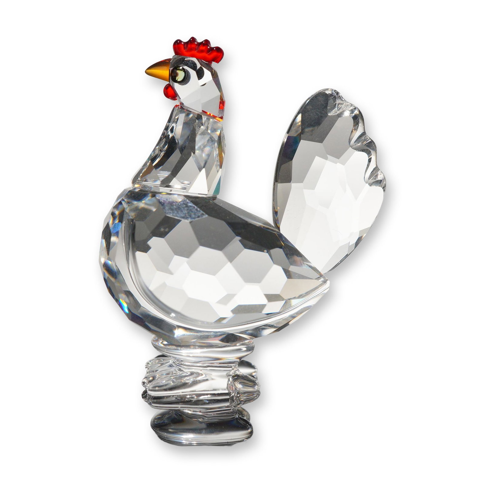 Swarovski Faceted Crystal Red Crown Hen Figurine: Swarovski Austrian lead crystal figurine of a hen, model 608721. The piece is constructed with a clear multi-faceted body and fanned tail, accented by a red crystal comb and wattle, a yellow-orange cr