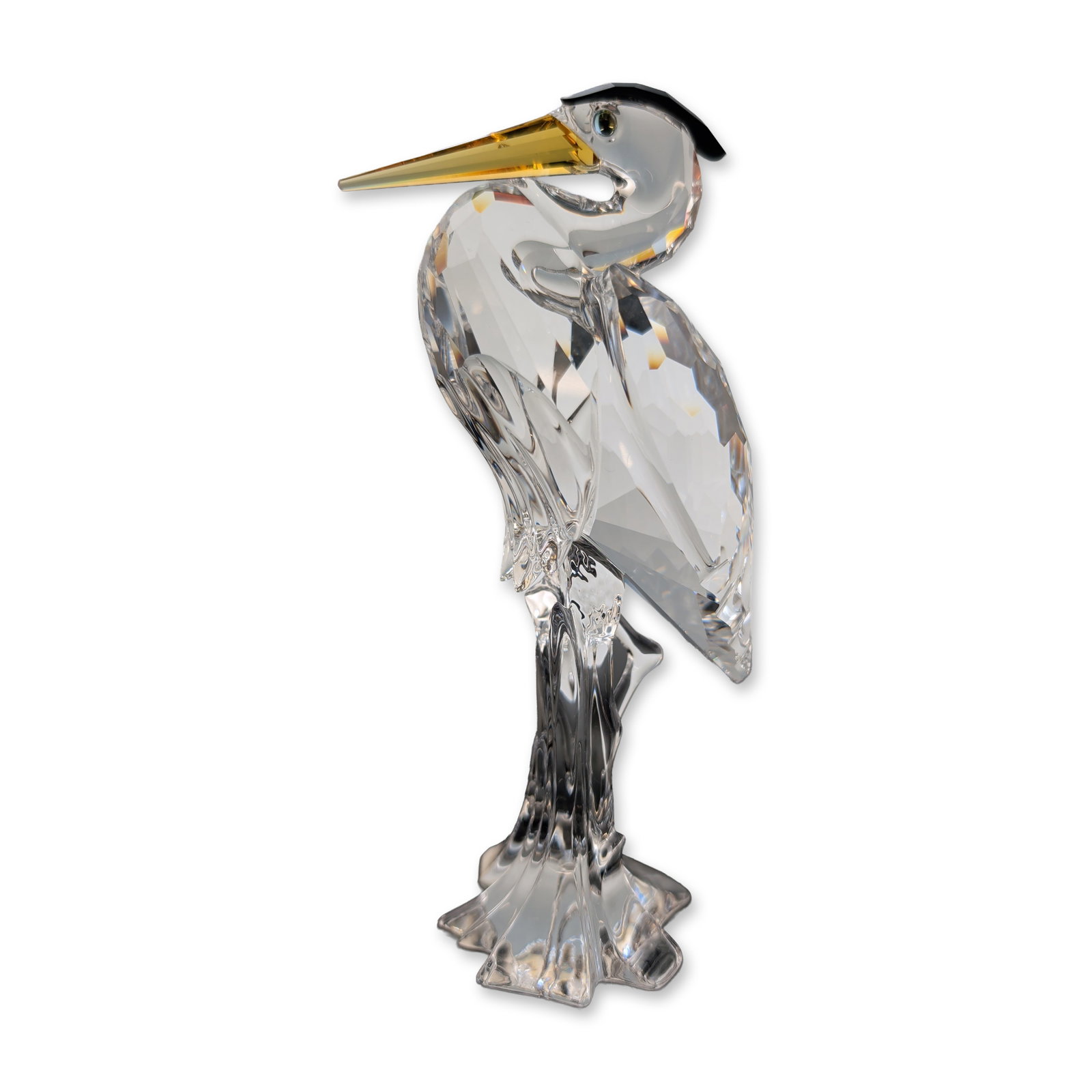 Swarovski Silver Crystal Figurine with Box, Silver Heron by Adi Stocker: Swarovski Silver Crystal Silver Heron figurine, designed by Adi Stocker. The bird is rendered in faceted clear lead crystal with a yellow colored beak and a small black crystal head crest. The figure 