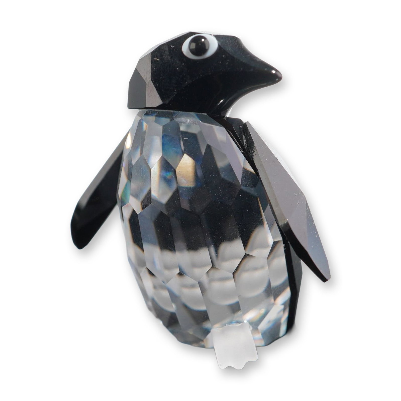 Swarovski Crystal Figurine, Madame Penguin: Swarovski. Madame Penguin figurine from the Silver Crystal collection. Faceted lead crystal construction with a clear body, black faceted head and wings, and frosted crystal feet. Features applied eye