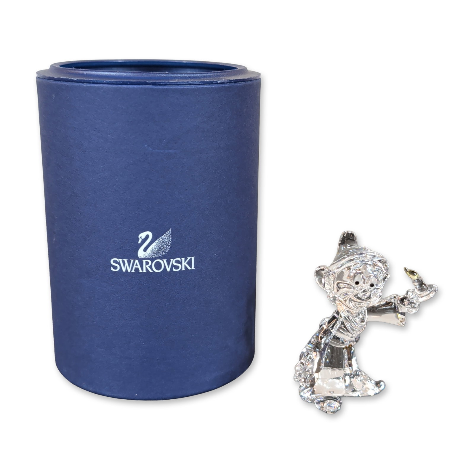 Swarovski Crystal Disney Dopey Figurine: Swarovski Disney Dopey figurine from the Snow White and the Seven Dwarfs collection, rendered in clear faceted lead crystal with black jet crystal eyes and a yellow-toned crystal bell accent on the ha