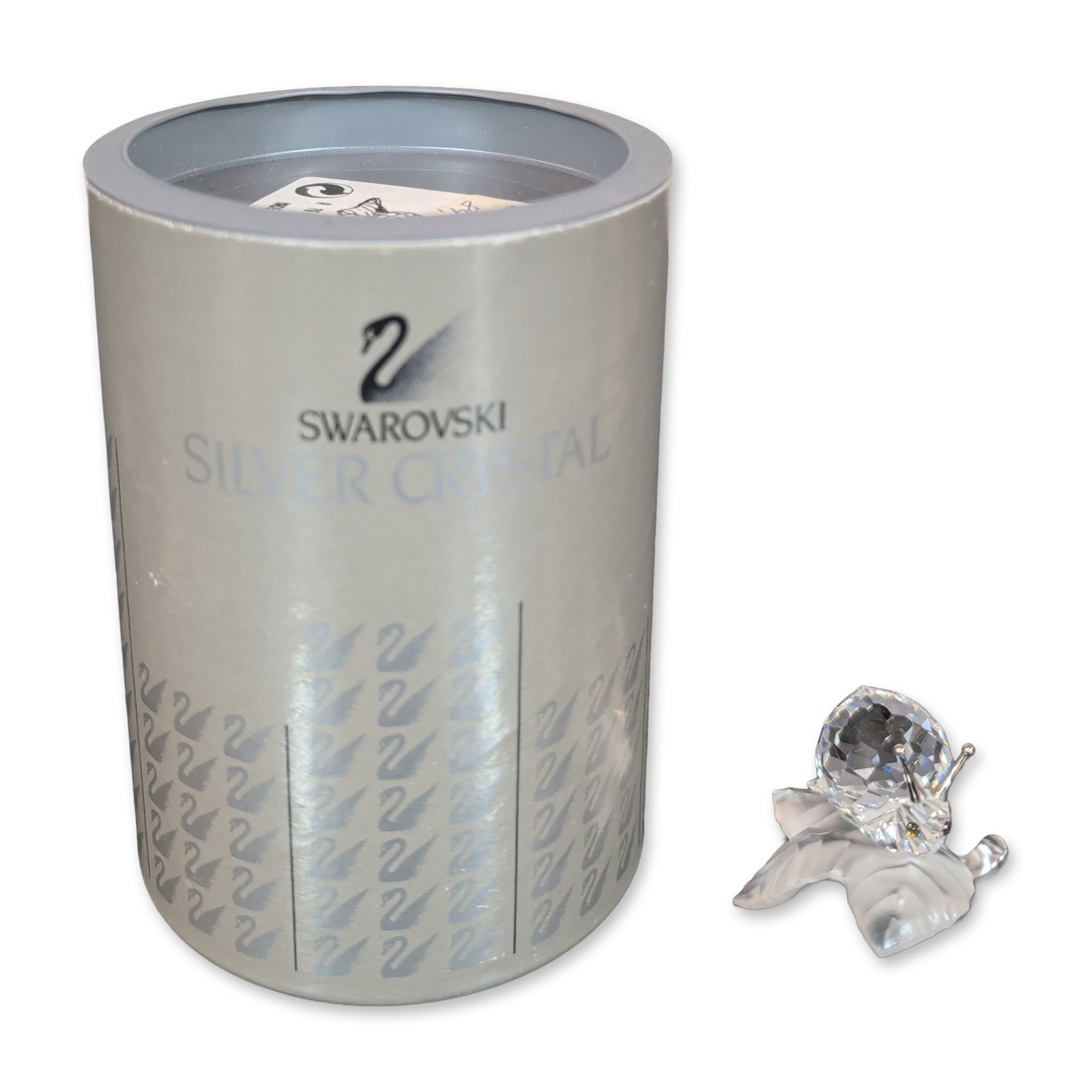 Swarovski Silver Crystal Snail on Leaf Figurine: Swarovski Silver Crystal figurine depicting a snail resting on a leaf. The piece features a faceted clear crystal shell, smooth crystal head and body, and two silver-tone metal antennae. The snail is 