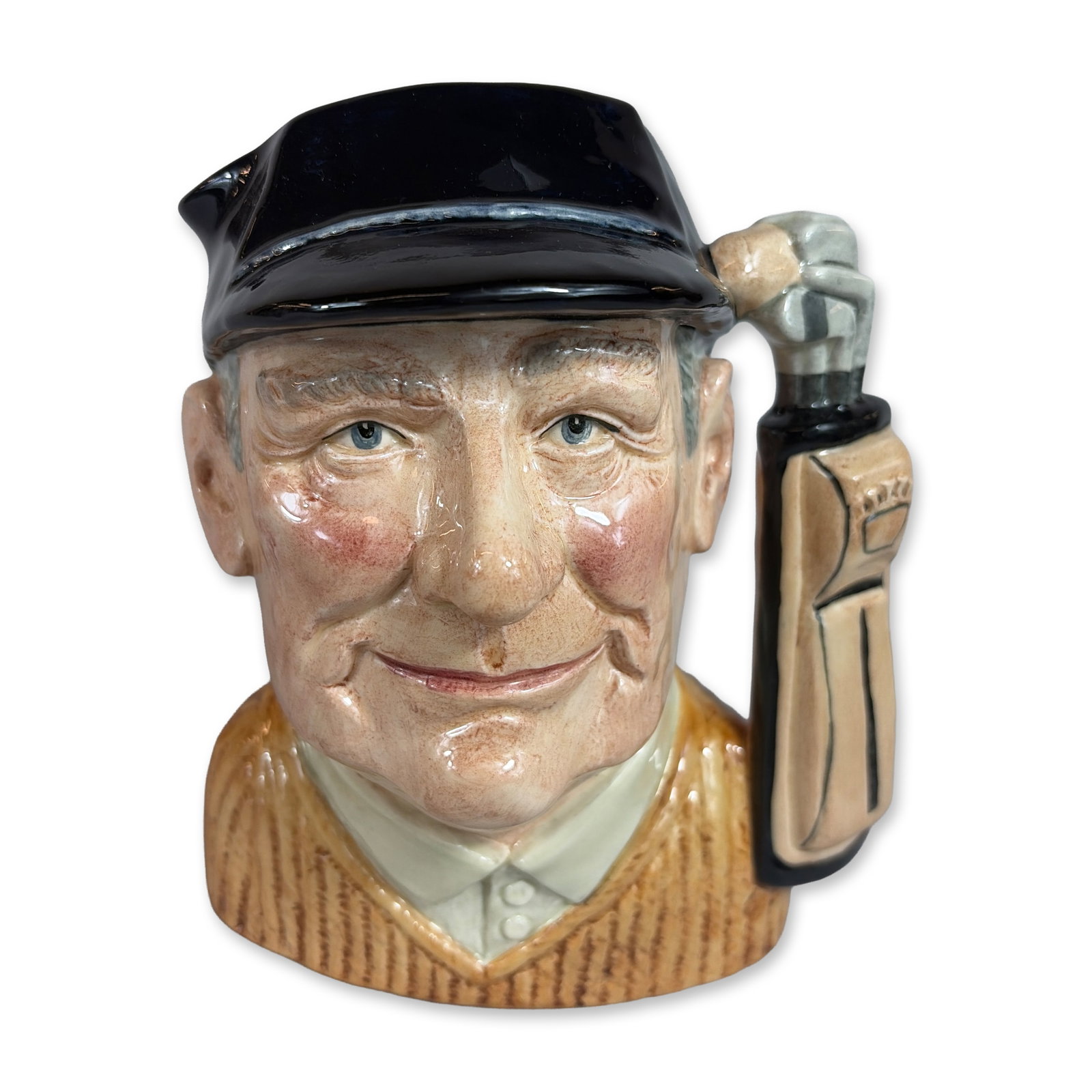 Royal Doulton Golfer D6623 Ceramic Character Jug: Royal Doulton. Large character jug in glazed ceramic, titled Golfer and designed by David B. Biggs. The piece depicts a man with a jovial expression and rosy cheeks, wearing a black flat cap and a yel