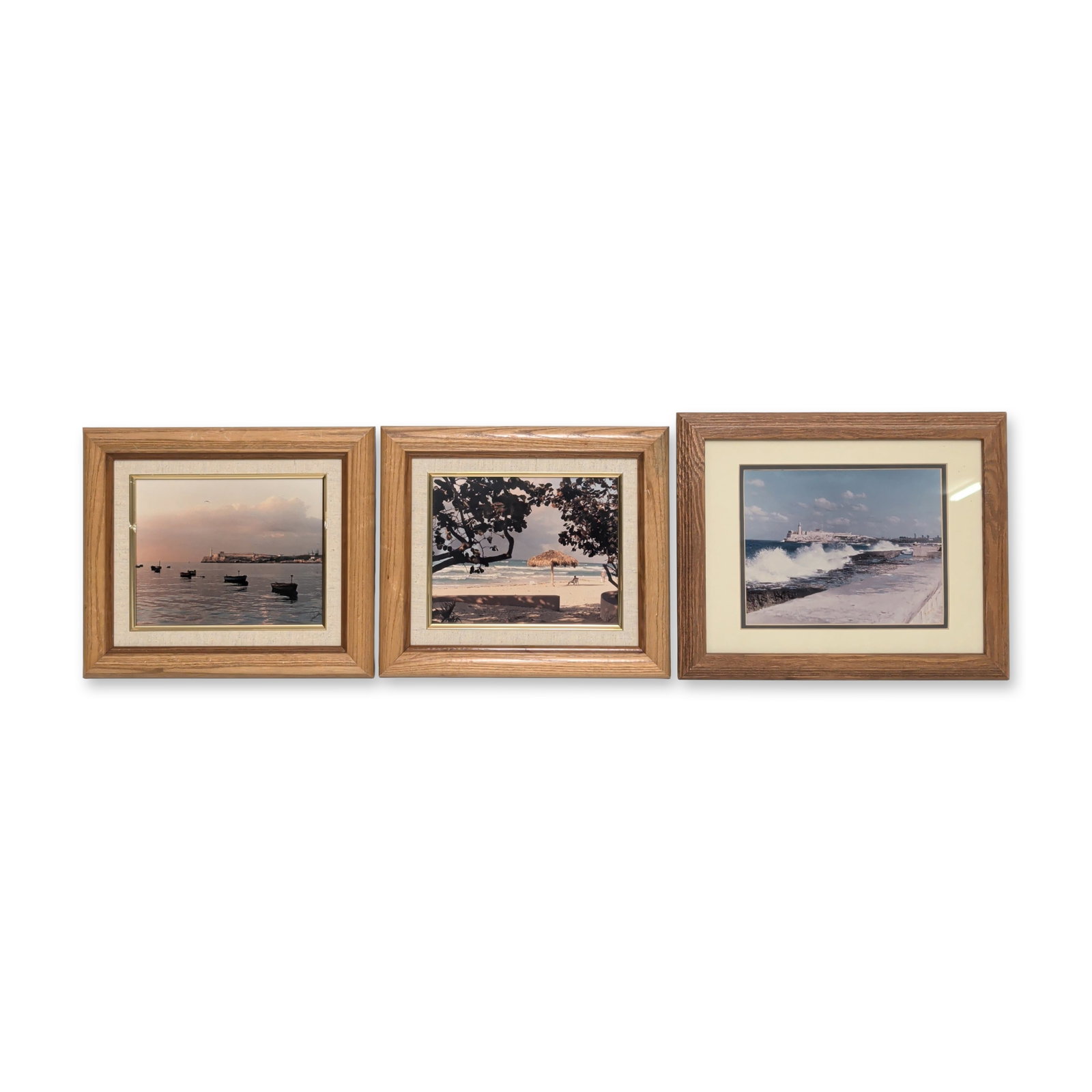 3pcs Chromogenic Prints on Paper, The Malecon, El Moro Havana & Cuban Beach Scene, Signed: Set of three framed chromogenic prints on paper depicting The Malecon Seawall and El Morro Castel in Havana and a Cuban beach scene. Housed in light brown wooden frames with cream mats, each bearing a