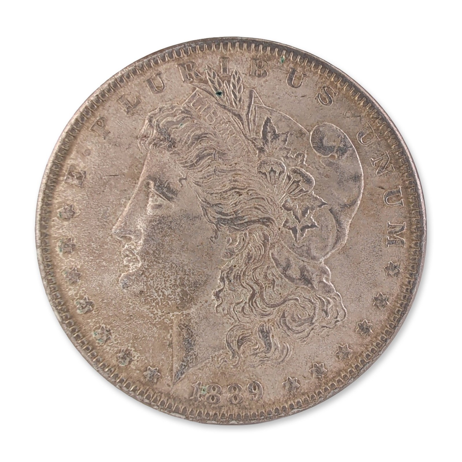 1889 US Morgan One Dollar Silver Coin, Circulated: United States, 1889. Morgan silver dollar in 90% silver, featuring the Liberty head obverse and eagle reverse designs. Inscribed E PLURIBUS UNUM, UNITED STATES OF AMERICA, and ONE DOLLAR. No mint