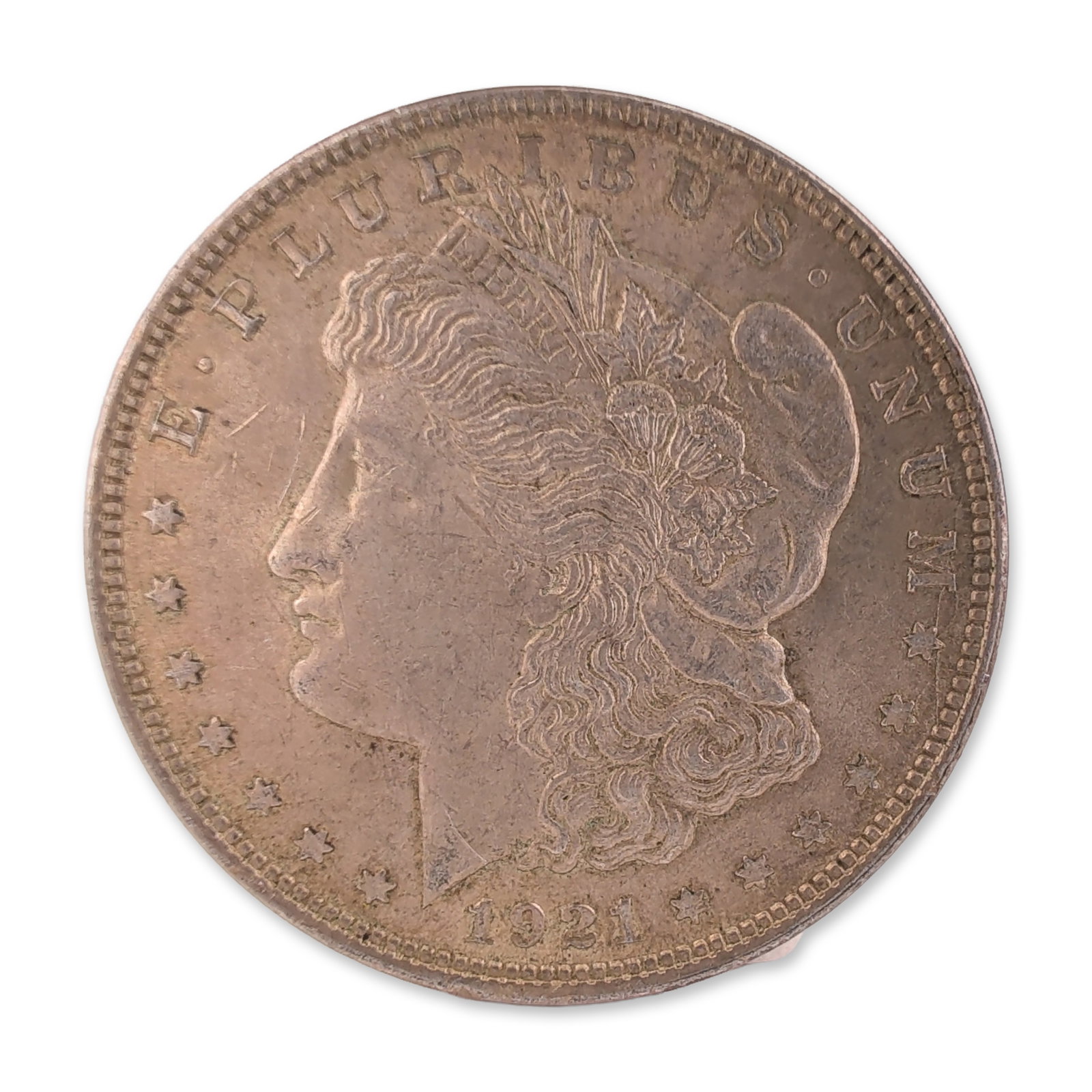 1921 US Morgan One Dollar Silver Coin, Circulated: 1921 US Morgan silver dollar, Philadelphia Mint. Die-struck in 90% silver, the obverse displays a profile of Liberty while the reverse features a heraldic eagle within a wreath. 1921 was the concludin