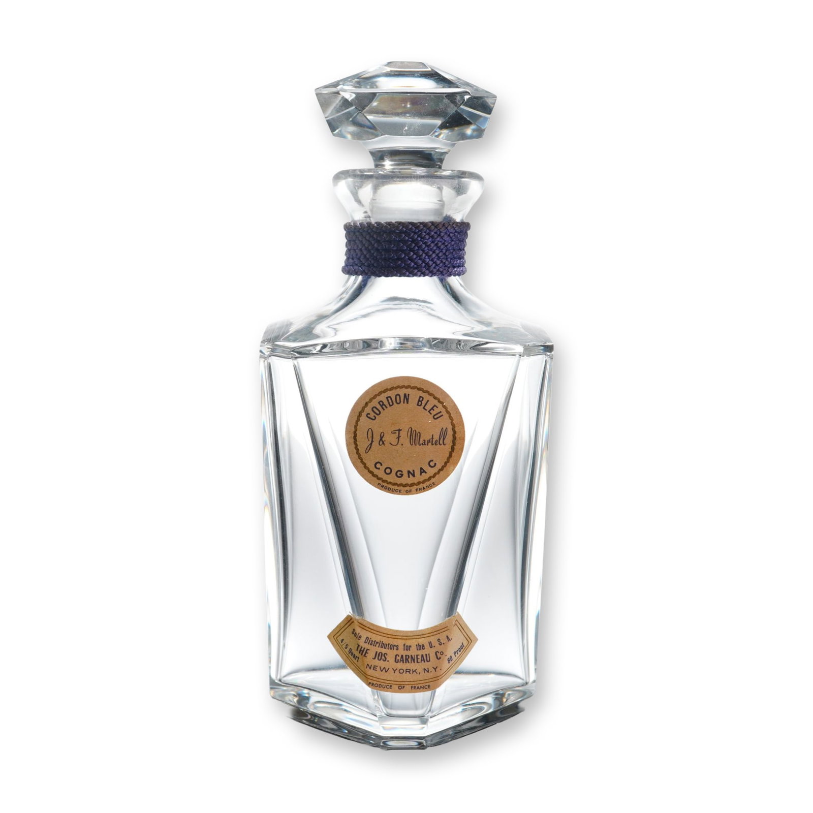 Martell Cordon Bleu Baccarat Crystal Decanter: This lead crystal spirits decanter was produced by Baccarat Crystal for Martell Cordon Bleu Cognac. The vessel features a tapered hexagonal body with deep faceted cutting and a matching faceted crysta
