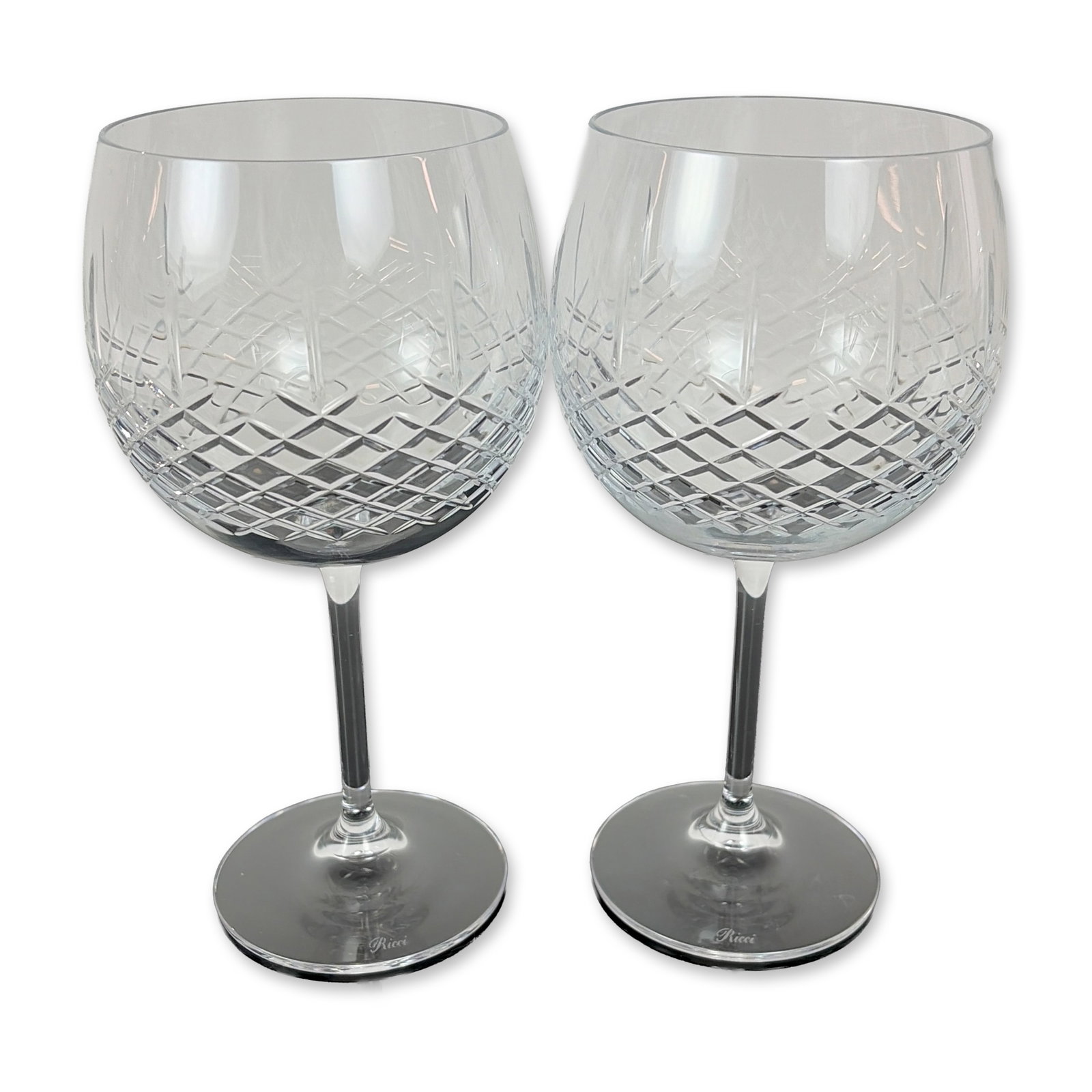 Pair of Ricci Cut Crystal Balloon Wine Glasses: Set of two Ricci Argentieri cut crystal wine glasses. Each glass features a globular bowl decorated with a precision diamond cut pattern to the lower half, transitioning to a clear upper section. The 