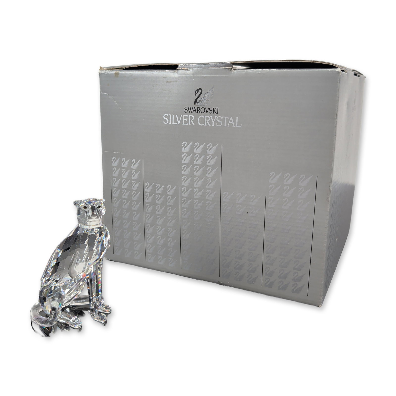 Swarovski Silver Crystal Faceted Cheetah Figurine, Var. 2: From the African Wildlife collection, this exquisite piece is crafted from faceted clear lead crystal and portrays a cheetah in a graceful prowling stance, with elongated limbs and a long, curved tail