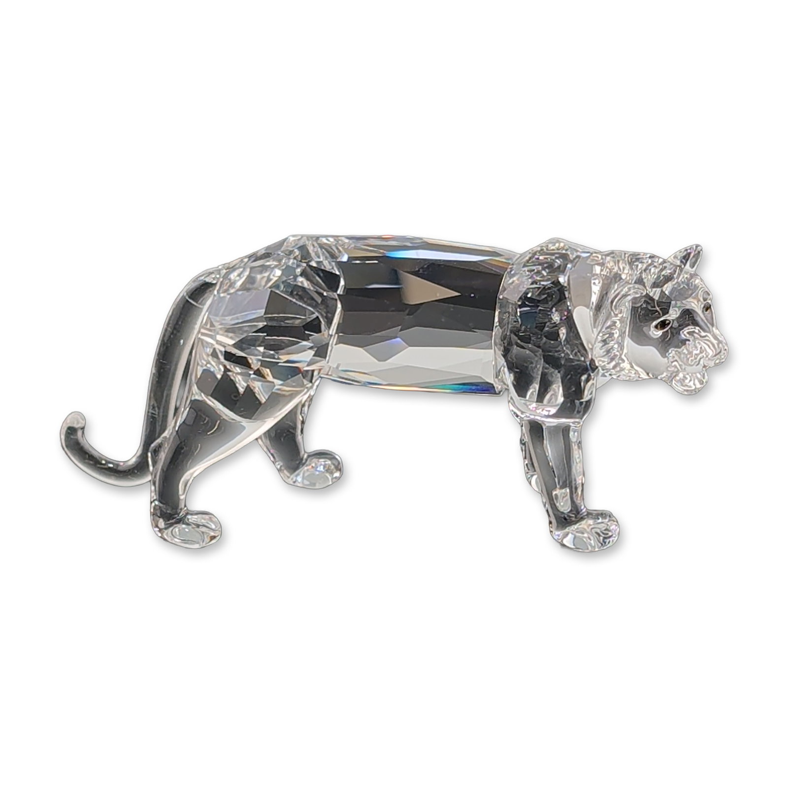 Swarovski Silver Crystal Tiger Figurine: Swarovski Silver Crystal tiger figurine crafted in faceted lead crystal with molded head, paws, and tail. Features an acid-etched swan logo mark to the underside of one paw. Accompanied by original Sw