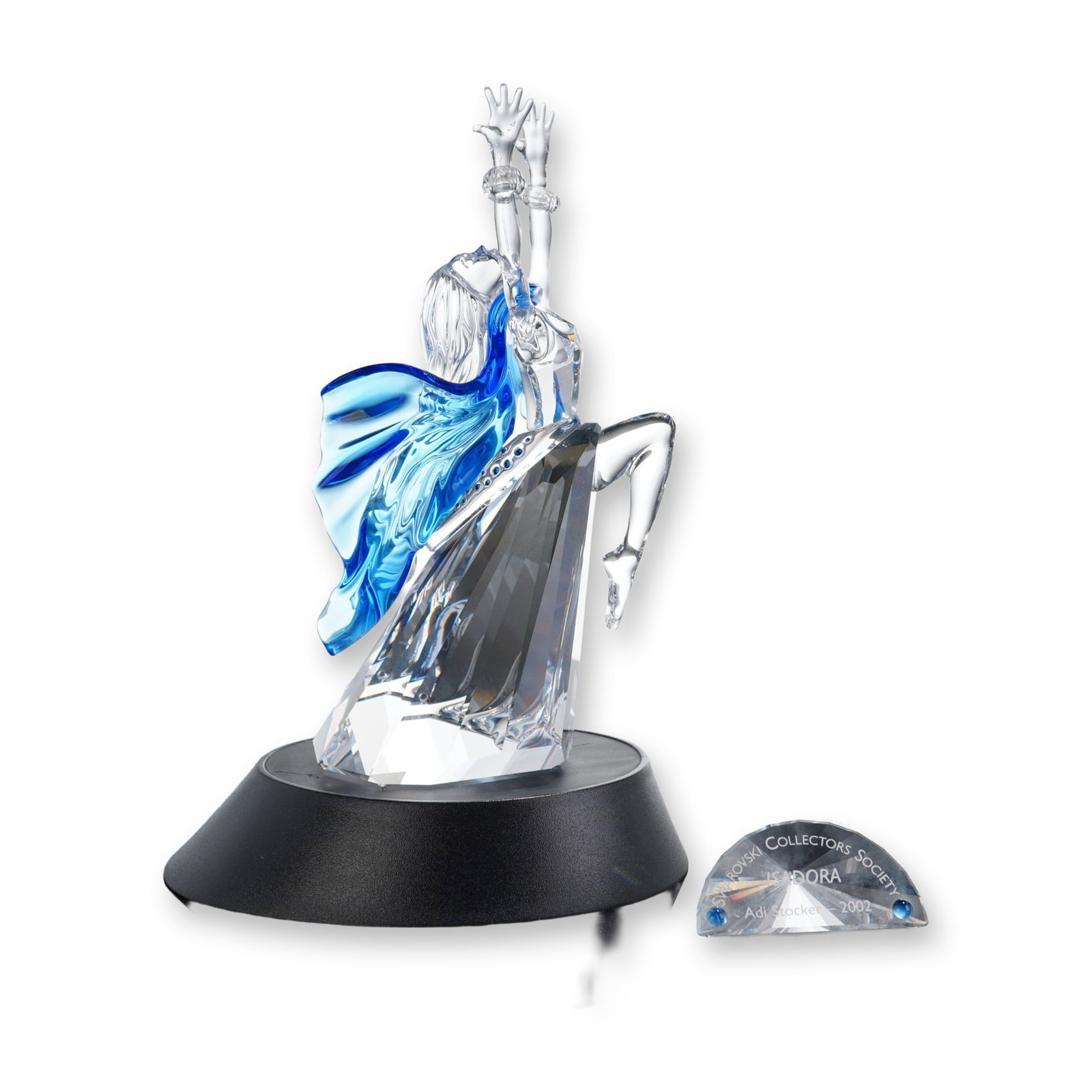 Swarovski SCS 2002 Annual Edition Figurine, Isadora, Title Plaque and Base: Swarovski Crystal Society 2002 Annual Edition figurine titled Isadora, designed by Adi Stocker for the Magic of Dance trilogy. Crafted in faceted clear and cobalt blue crystal, the figure depicts a