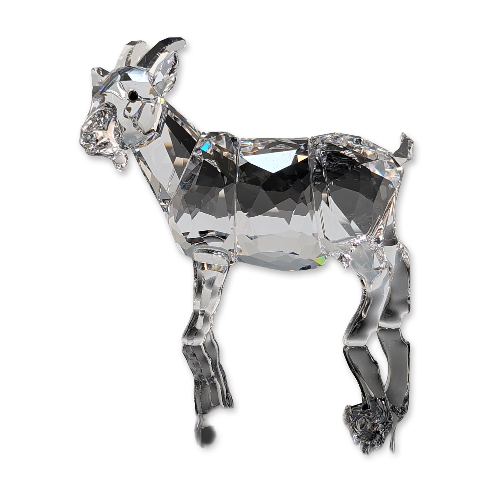 Swarovski Austrian Faceted Crystal Goat Figurine: Swarovski clear faceted crystal figurine depicting a goat constructed from multi-faceted Austrian lead crystal designed for light refraction. Features a swan logo on the underside of one foot. Accompa