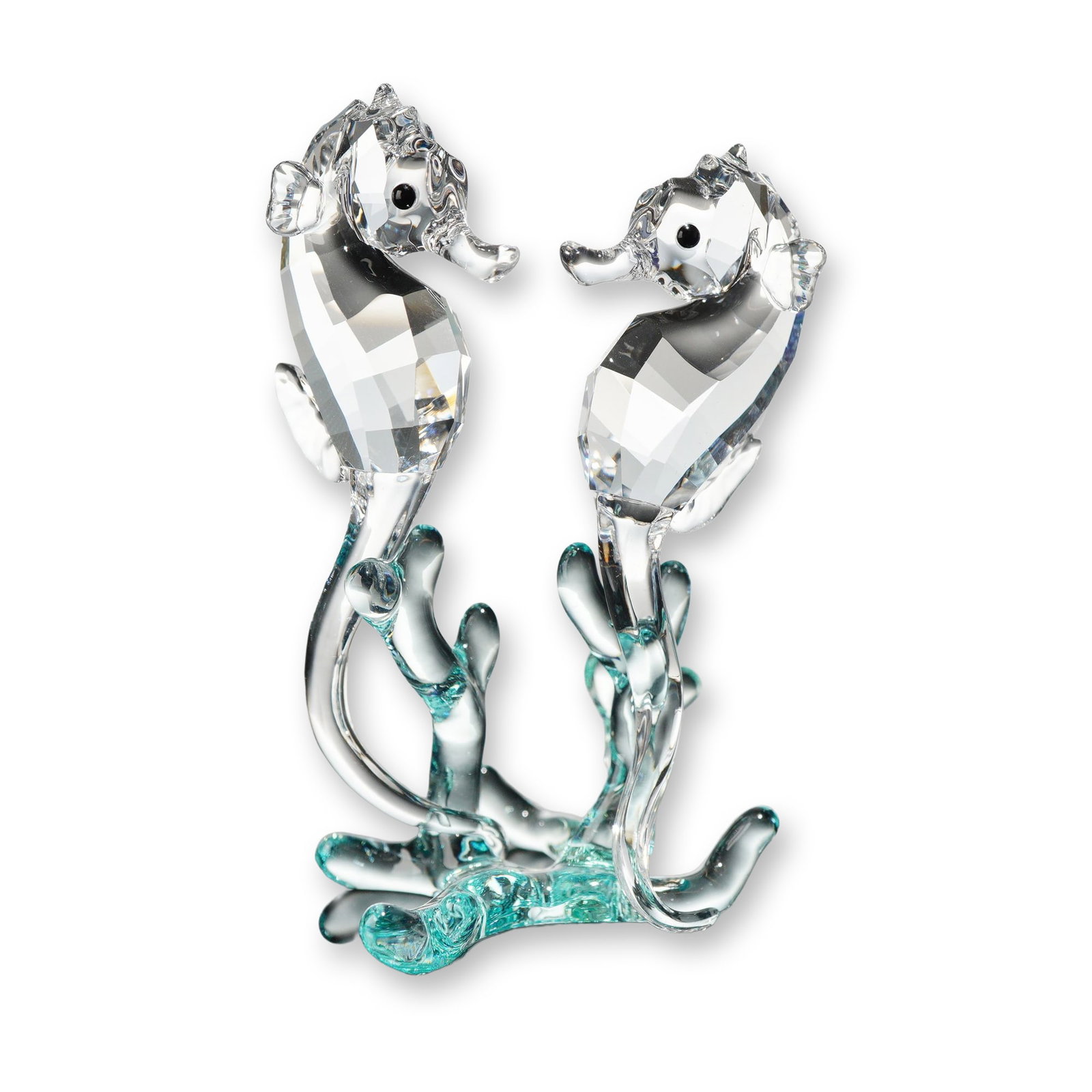 Swarovski Crystal Figurine, Seahorses: Swarovski crystal figurine depicting two seahorses, model 885589. Designed with two faceted clear lead crystal seahorses perched on a smooth, aqua-blue tinted crystal coral base. The seahorses feature