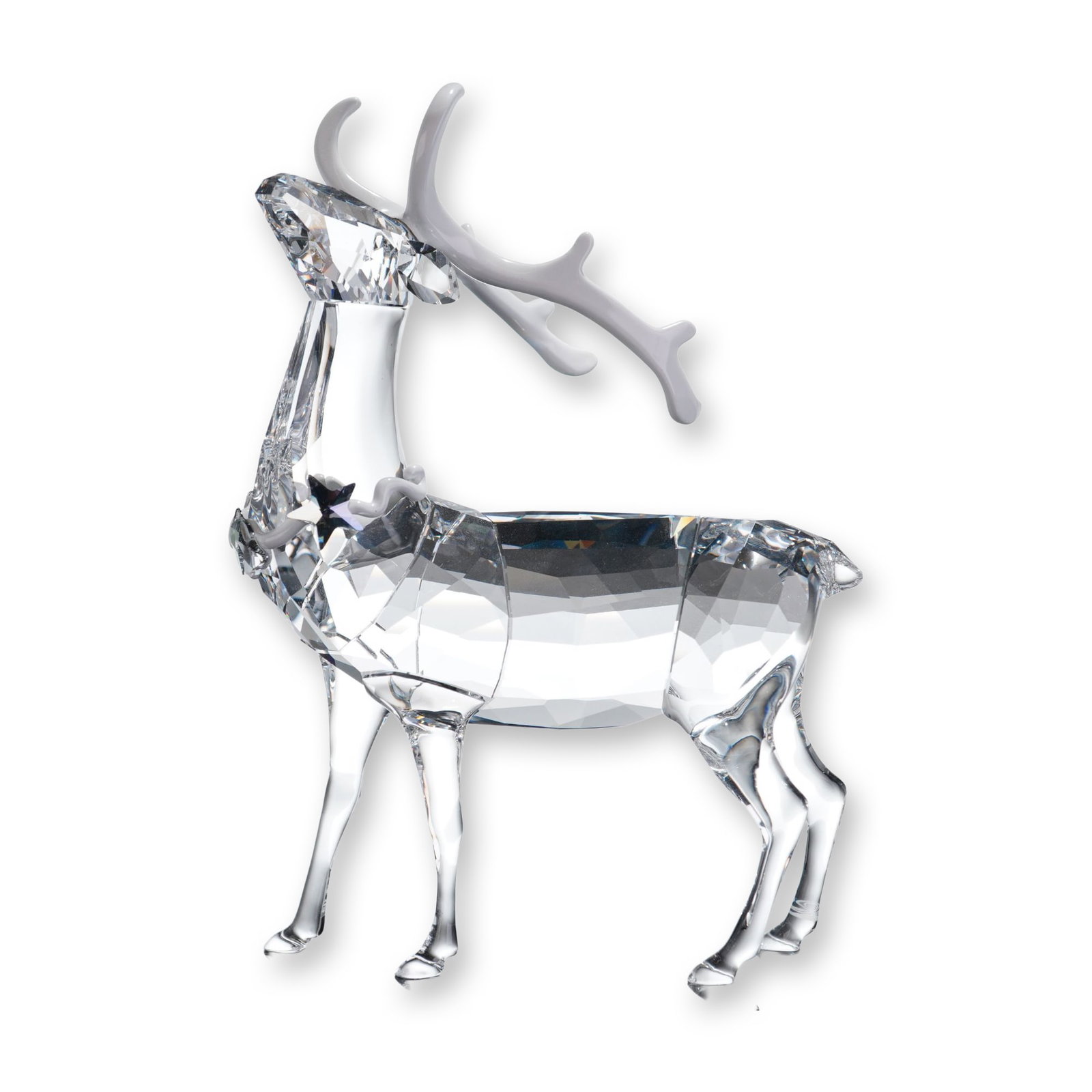 Swarovski Crystal Figurine, Christmas Stag with White Lacquered Antlers: Christmas stag figurine in faceted clear lead crystal, featuring white lacquered metal antlers. The figure is accented with a gray cord collar suspending a multi-faceted clear crystal star pendant. Ac
