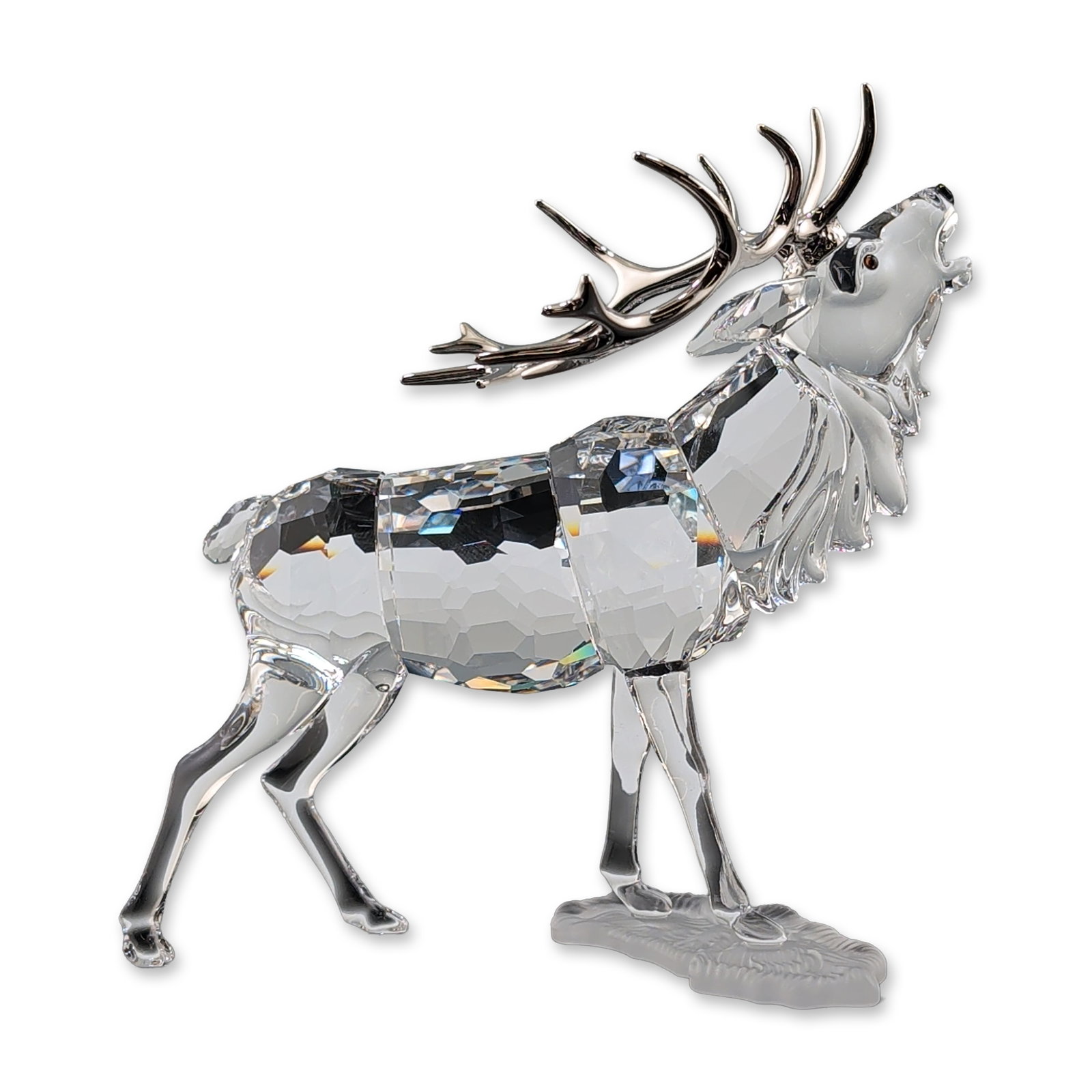 Swarovski Crystal Stag Figurine: Swarovski crystal stag figurine designed with a faceted crystal body, neck, and head, and smooth crystal legs. The figure is depicted in a dynamic pose on a frosted crystal base with textured ground d