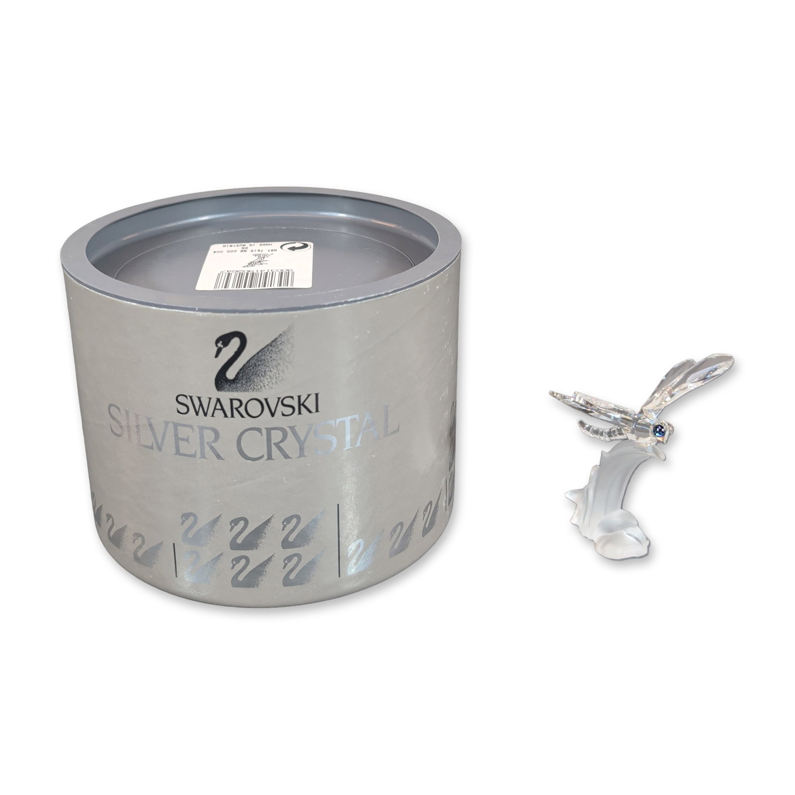 Swarovski Silver Crystal Dragonfly Figurine: Swarovski Silver Crystal dragonfly figurine from the In the Secret Garden series. The piece features a faceted clear crystal dragonfly with sapphire-colored crystal eyes perched on a frosted crystal l