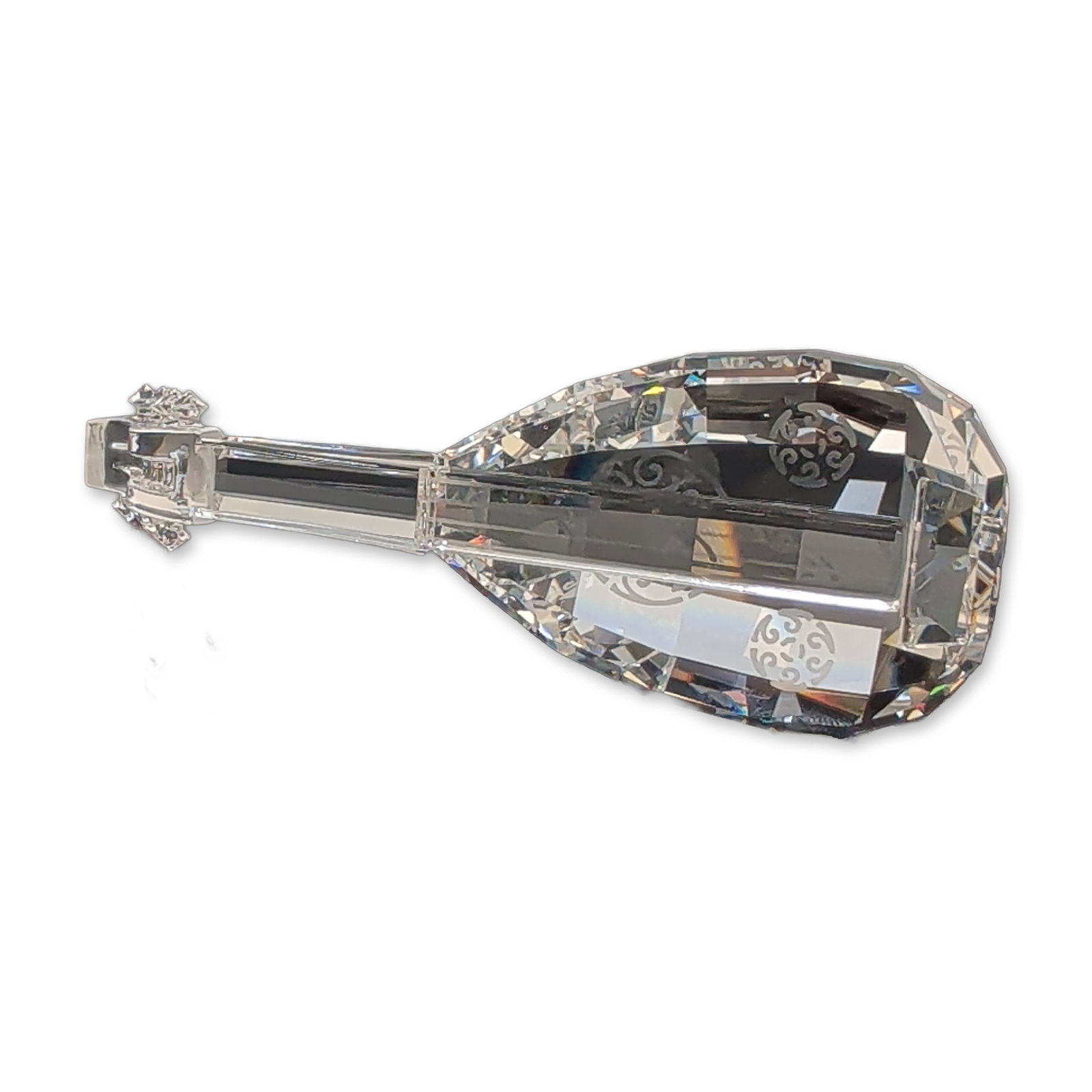 Swarovski Silver Crystal Figurine, Lute: Swarovski Silver Crystal figurine depicting a lute. The clear lead crystal instrument features a multi-faceted body decorated with four etched circular scrollwork motifs on the front face. The piece i
