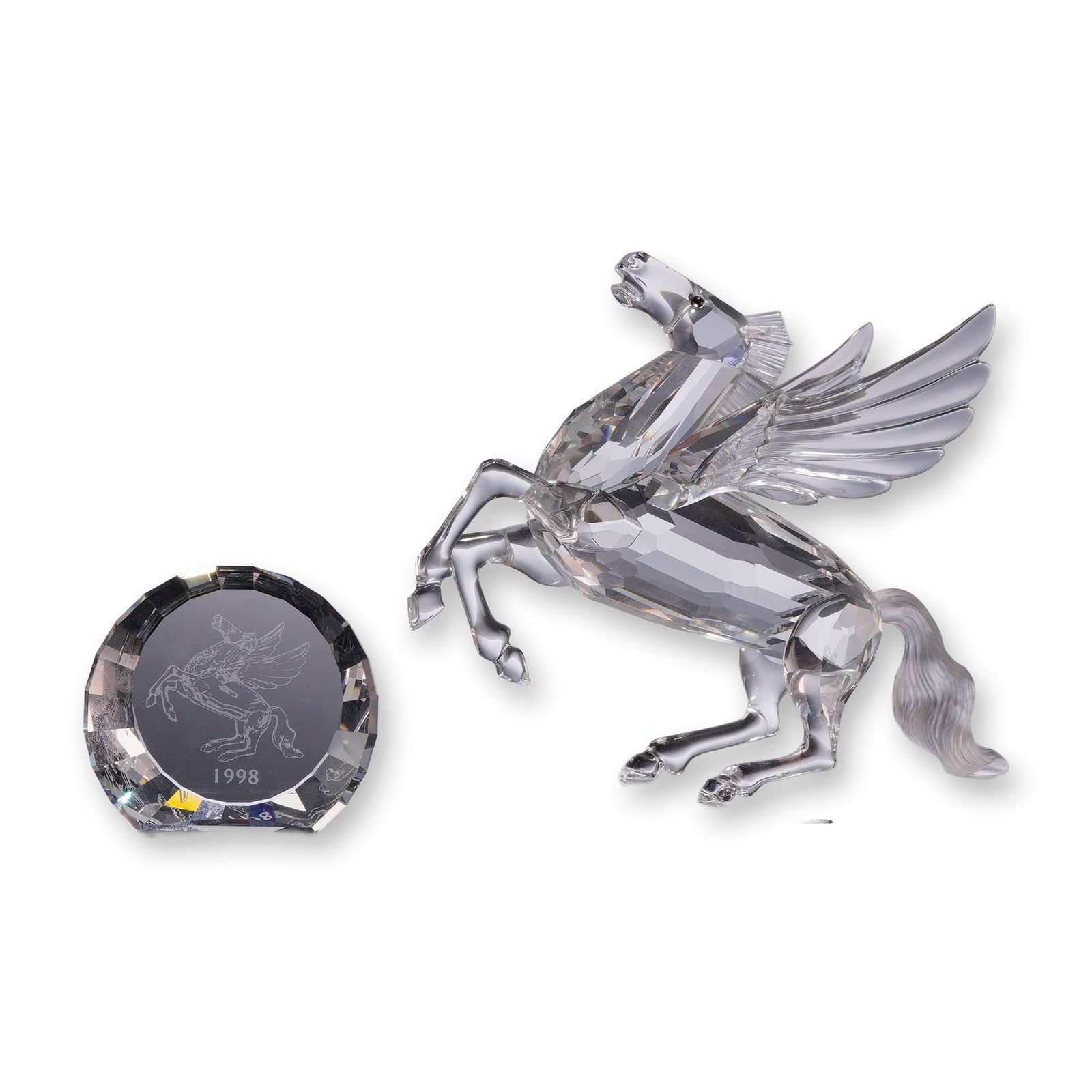 Two Swarovski Crystal Pegasus Pieces: Swarovski Crystal Society (SCS) 1998 Annual Edition Pegasus figurine from the Fabulous Creatures series, designed by Adi Stocker, accompanied by the matching 1998 SCS Pegasus title plaque. Constructed