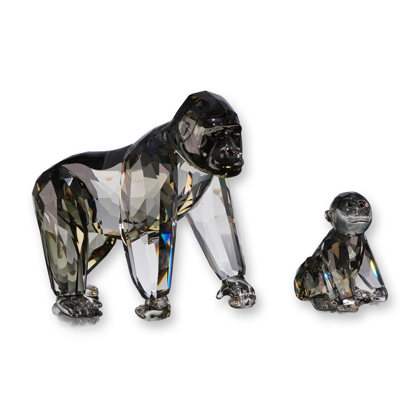 Swarovski Crystal 2009 Annual Edition Gorilla Mother and Cub Set: Swarovski Crystal Society 2009 Annual Edition Gorilla and companion Young Gorilla figurines, designed by Anton Hirzinger. Each piece is crafted in multi-faceted black diamond crystal with a dark gray 