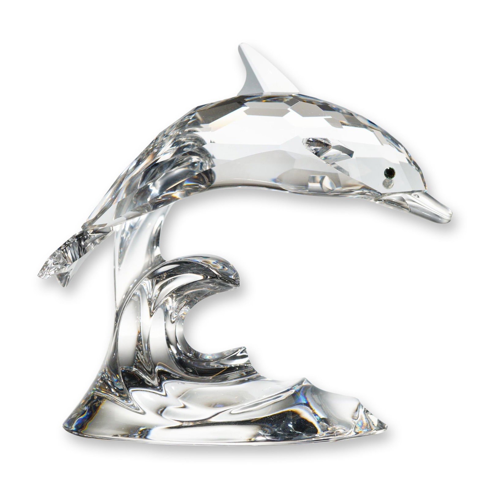 Swarovski Crystal Dolphin on Wave: Swarovski Silver Crystal. Figurine in lead crystal depicting a dolphin leaping over a cresting wave. The dolphin is designed with a faceted body, smooth-finished fins and tail, and inset dark stone ey