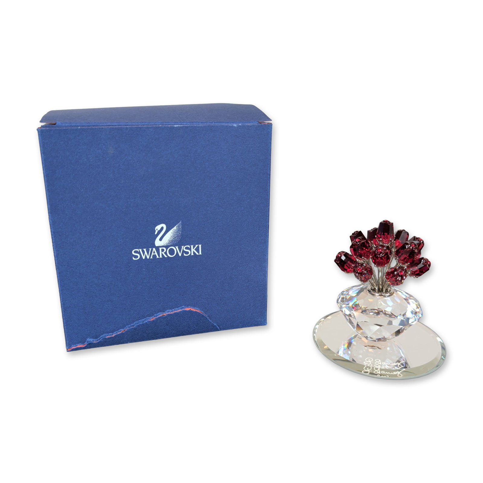 Swarovski Crystal Vase of Roses Jubilee Edition: Swarovski faceted lead crystal figurine titled Vase of Roses, released as a 15th Anniversary Jubilee edition in 2002. The piece features a bouquet of faceted red crystal blossoms mounted on silver-ton