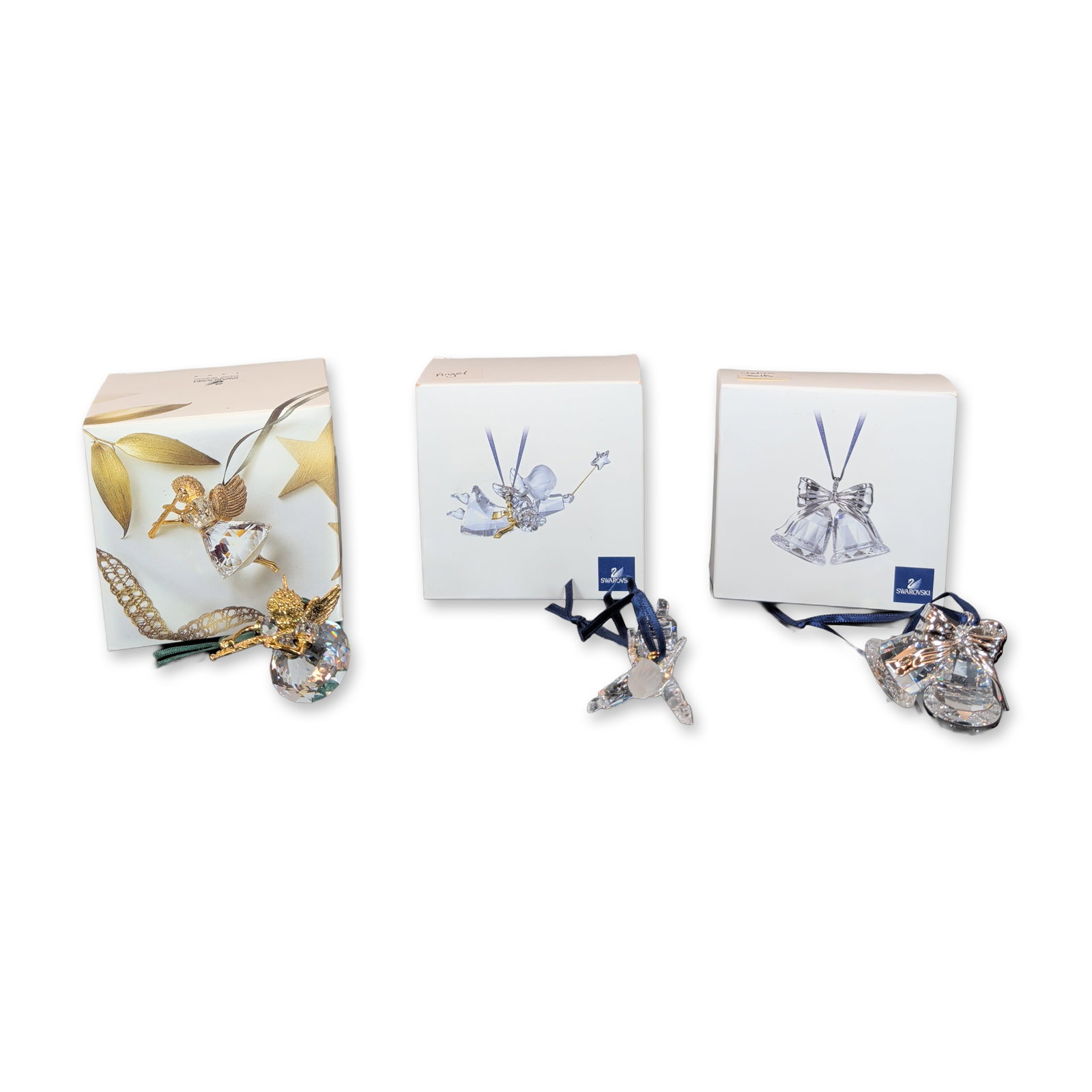 3pc Swarovski Faceted Lead Crystal Christmas Ornaments: Three Swarovski Christmas ornaments in faceted lead crystal and metal, comprising a pair of bells with a silver-tone bow, an angel with a star wand and frosted head, and a cherub with a gold-tone uppe