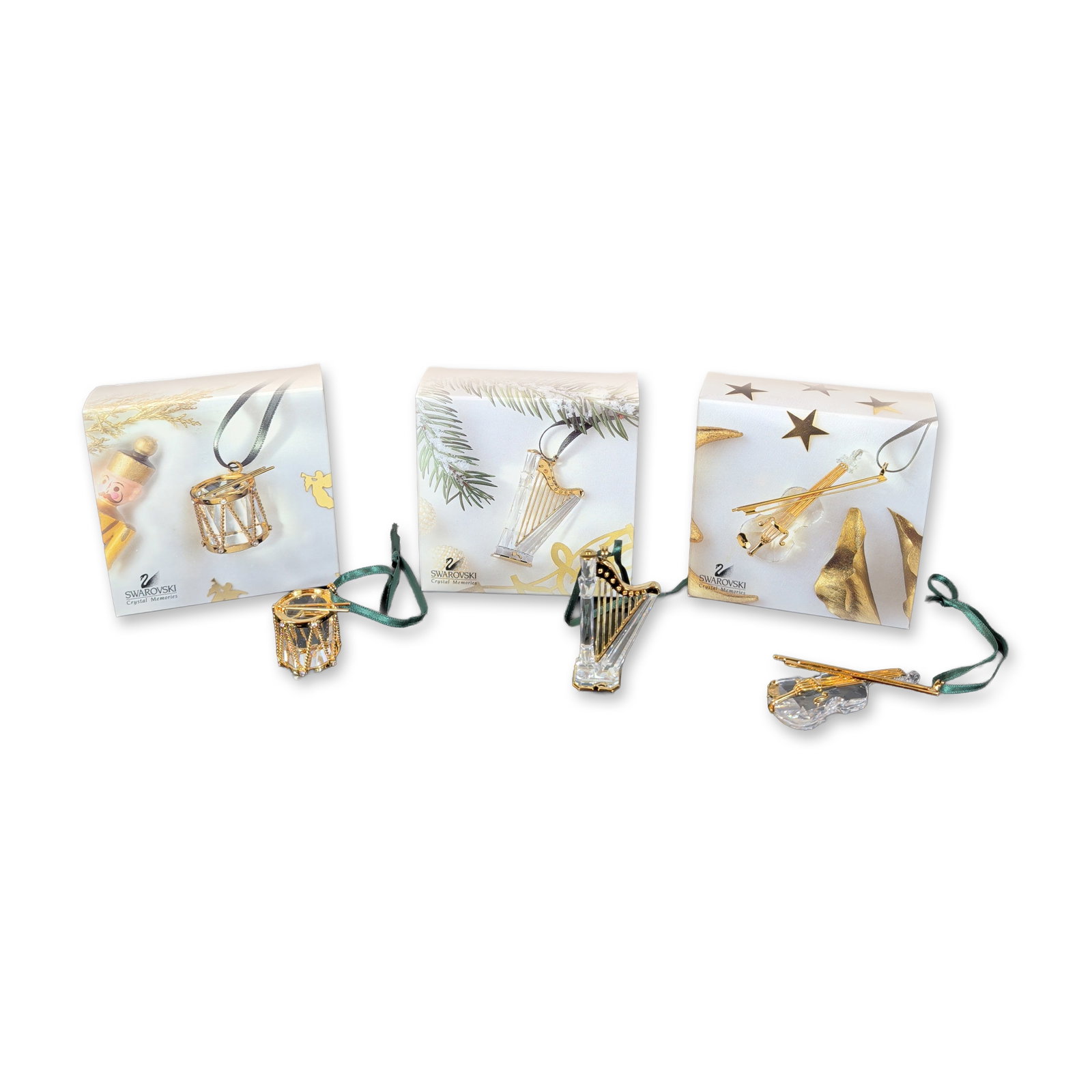 3pc Swarovski Crystal Memories Musical Ornaments: Swarovski Crystal Memories collection trio of musical instrument ornaments in faceted lead crystal with gold-toned metal hardware. The grouping includes a violin with a faceted body, gold-toned string