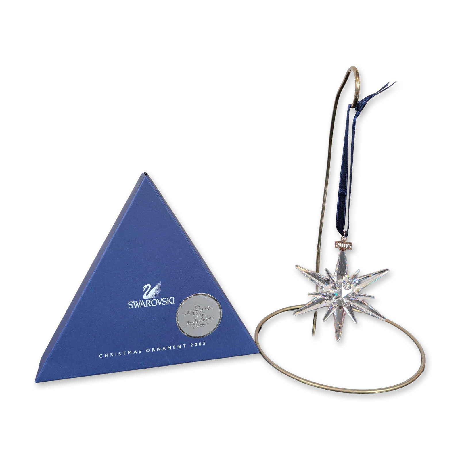 Swarovski 2005 Crystal Star Rockefeller Center Christmas Ornament: Annual edition star ornament in faceted clear crystal, produced as a commemorative edition for the 2005 Rockefeller Center Christmas tree star. The multi-pointed faceted crystal star is suspended from