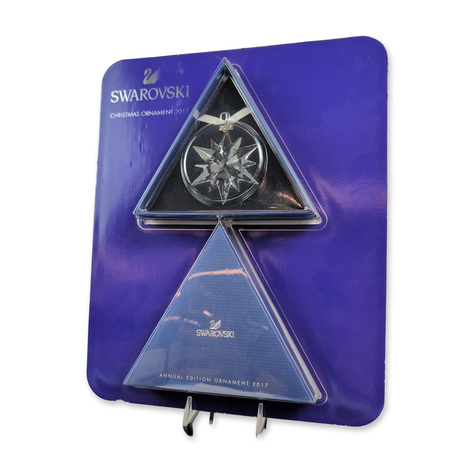 Swarovski 2017 Annual Edition Crystal Ornament: Swarovski 2017 Annual Edition Christmas ornament featuring a multi-faceted clear crystal star. The piece is suspended from a white satin ribbon and includes a polished silver-tone metal tag stamped 20