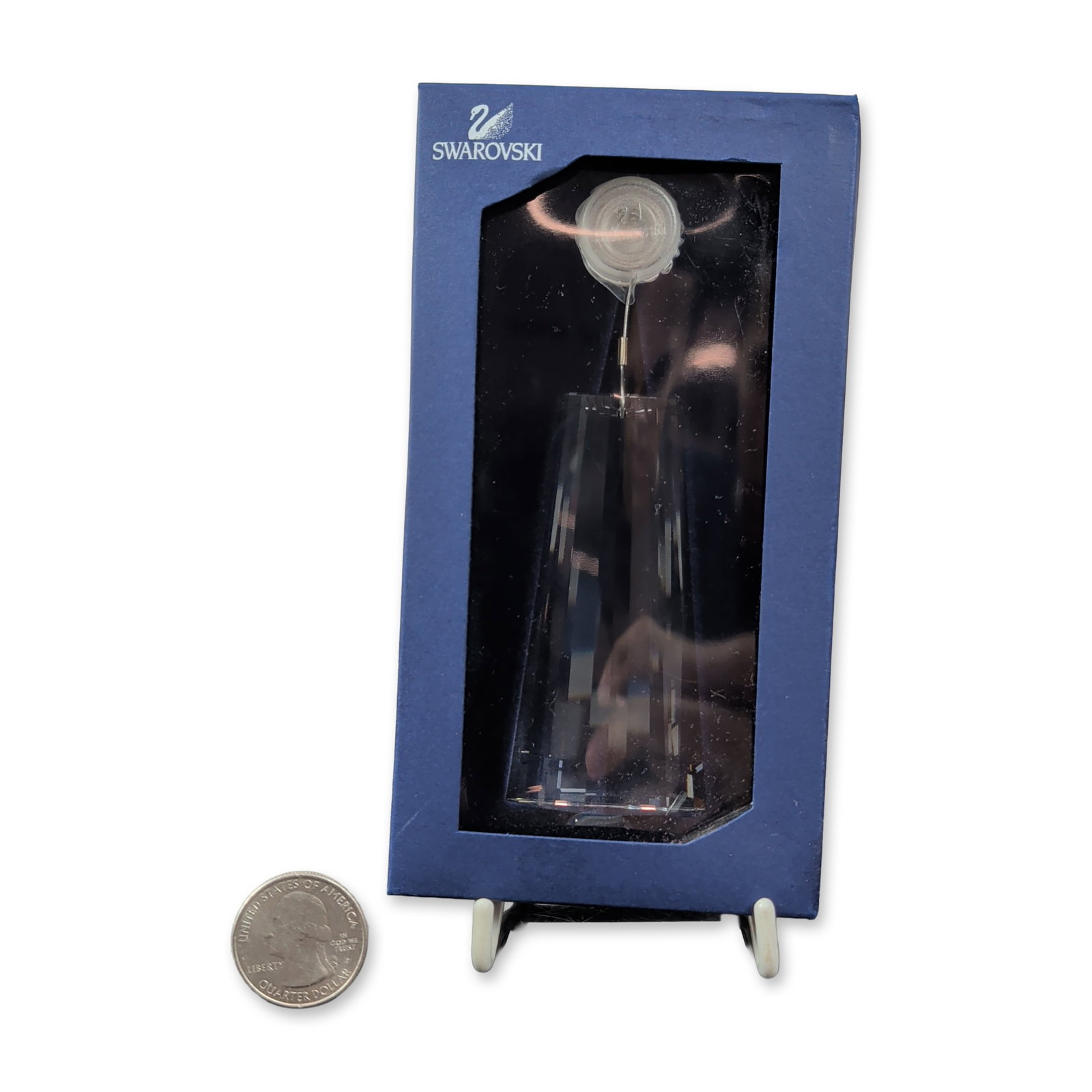 Swarovski Clear Crystal Faceted Wing Ornament: This Swarovski clear crystal multi-faceted suncatcher wing ornament dazzles with its brilliant sparkle. The crystal is suspended by a metal wire from a circular clear plastic mounting disk, and it com