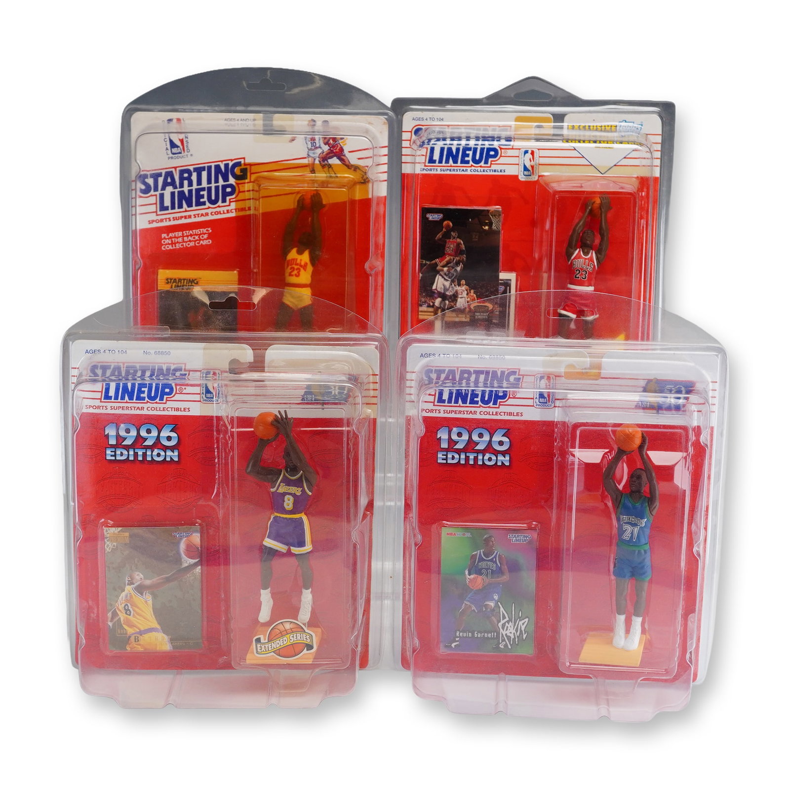 4pc NBA Starting Lineup Action Figures Including Kobe Bryant and Michael Jordan: A collection of four vintage Kenner Starting Lineup NBA action figures in original factory-sealed blister pack packaging. Each item is further protected by a clear plastic clamshell display case. The 