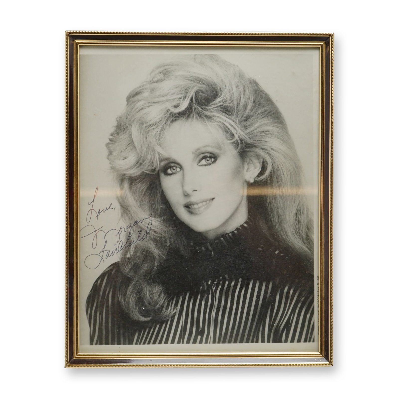 Morgan Fairchild Autographed 1982 Photograph by Harry Langdon: This autographed photograph of Morgan Fairchild features a black-and-white publicity portrait of the American actress. The image is a professional studio portrait captured by celebrity photographer Ha