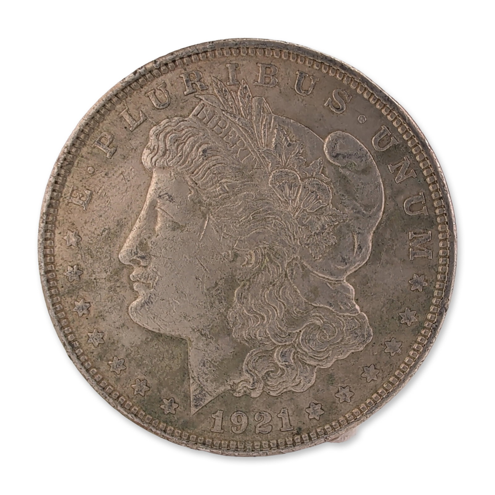 1921 US Morgan One Dollar Silver Coin, Circulated: US 1921 Morgan silver dollar, Philadelphia mint. Silver coin featuring the Morgan design obverse and eagle reverse. This circulated specimen lacks a mint mark and exhibits a reeded edge. Dimension 38.