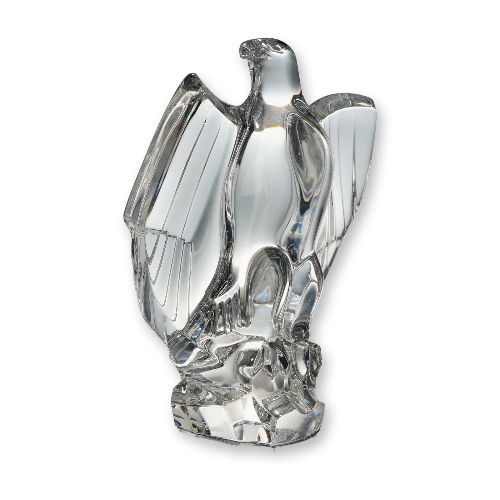 Baccarat Crystal Eagle Figurine: Figurine in clear lead crystal, depicting a stylized American eagle with wings partially spread, perched atop a textured, rock-like base. The sculpture features a smoothly polished head and body, whil