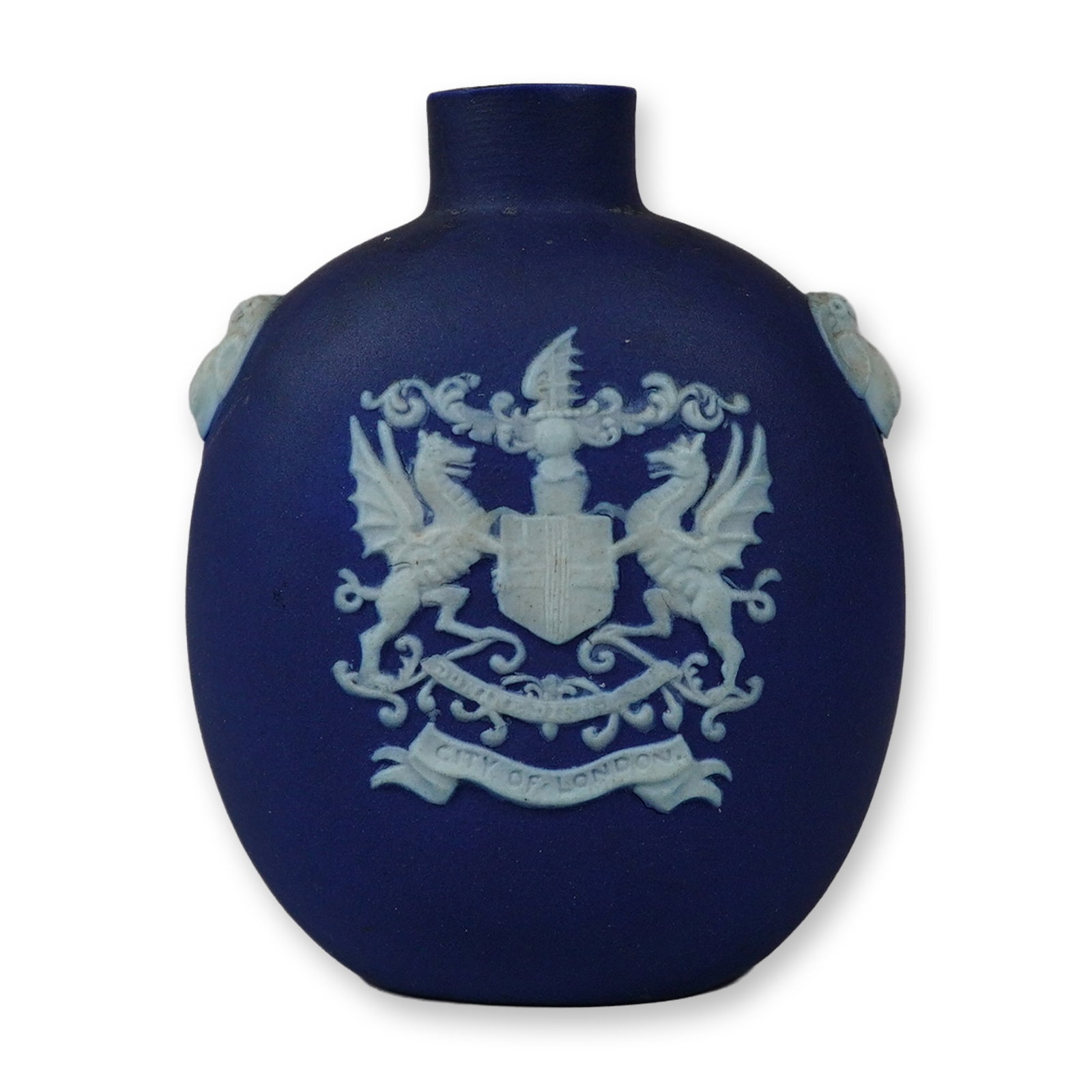 Wedgwood Cobalt Blue Jasperware City of London Small Bottle: A Wedgwood cobalt blue jasperware small bottle or miniature flask featuring a flattened circular body and short cylindrical neck. The front is decorated with a white sprigged relief of the Coat of Arm