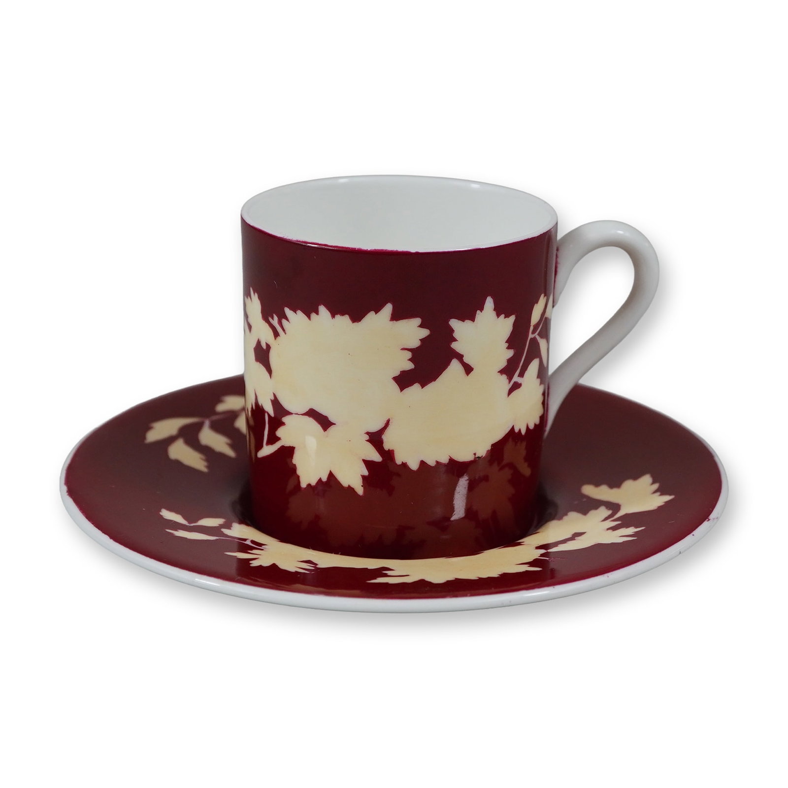 2pcWedgwood Bone China Coffee Cup and Saucer: A two-piece set comprising a coffee cup and matching saucer manufactured by Wedgwood in England. Each piece is constructed of fine bone china featuring a deep ruby red ground decorated with a contrast