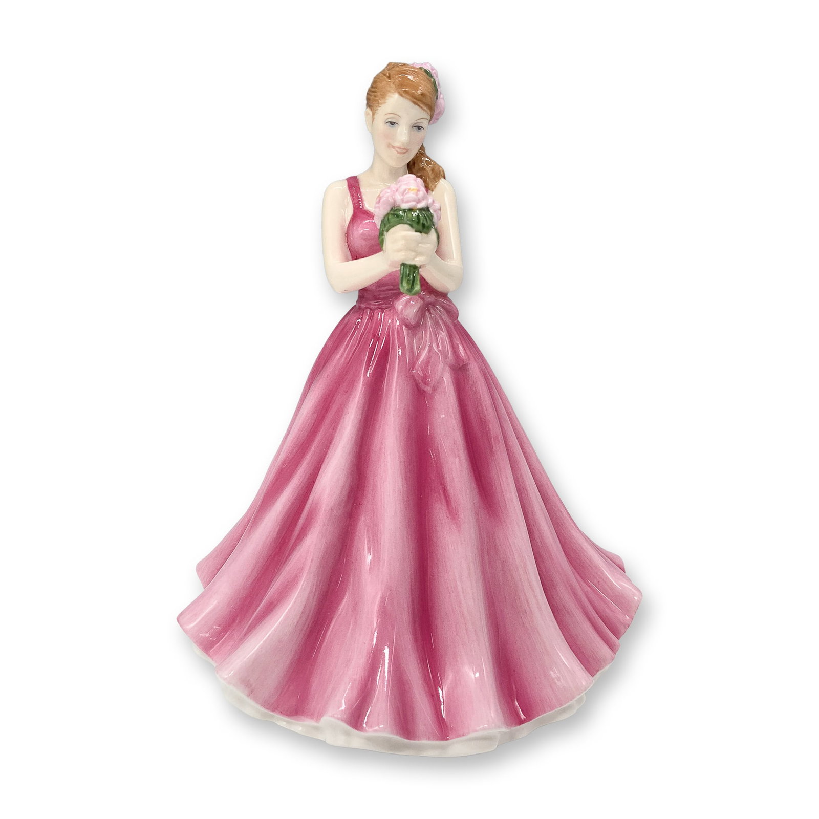 Royal Doulton Figurine, Flower of the Month May Peony HN5504: This Royal Doulton Flower of the Month series figurine, titled May Peony, features a young woman in a flowing pink gown holding a bouquet of peonies. Designed with intricate hand-painted details, this