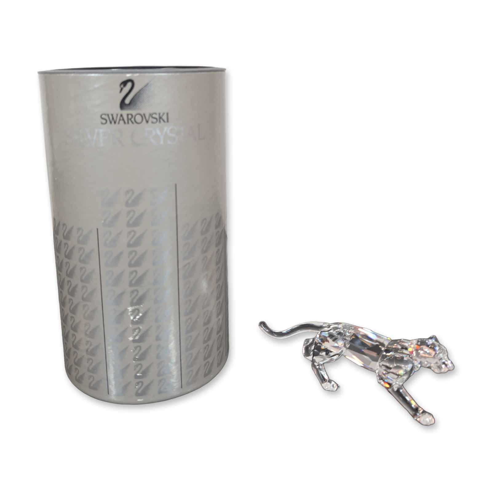 Swarovski Silver Crystal Leopard Figurine: The figurine depicts a leopard in a dynamic running pose with front legs extended and a smooth, curved tail. Features an etched Swarovski swan logo on the base. Accompanied by the original cylindrical