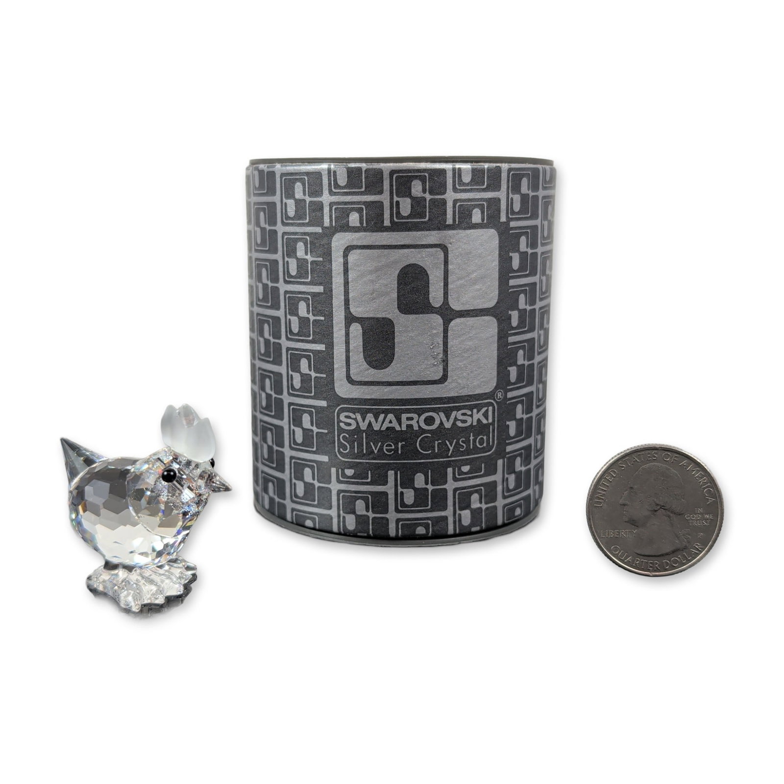 Swarovski Silver Crystal Mini Hen Figurine: This Swarovski crystal mini hen is crafted primarily from clear faceted crystal, featuring black eyes and a frosted comb, and is signed on the base by designer Gabriele Stamey. Part of the delightful 