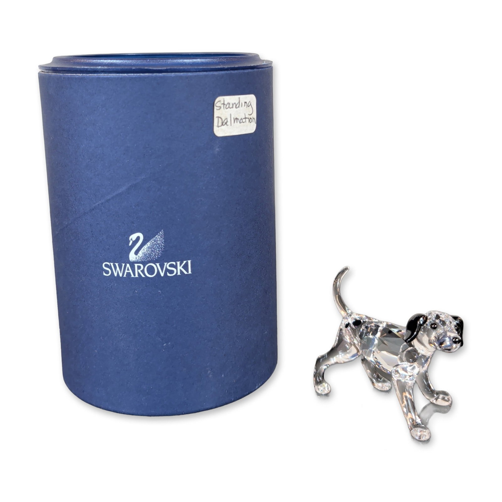 Swarovski Crystal Standing Dalmatian Puppy Figurine: Swarovski lead crystal figurine depicting a standing dalmatian, featuring a faceted clear crystal body with black crystal accents to the ears and tail. Acid-etched swan logo located on the underside o